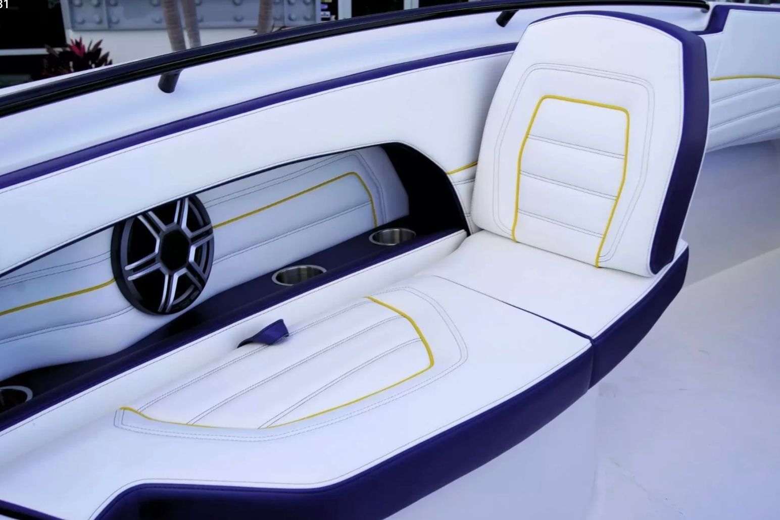 Sleek white and purple boat seating with yellow accents and a speaker.