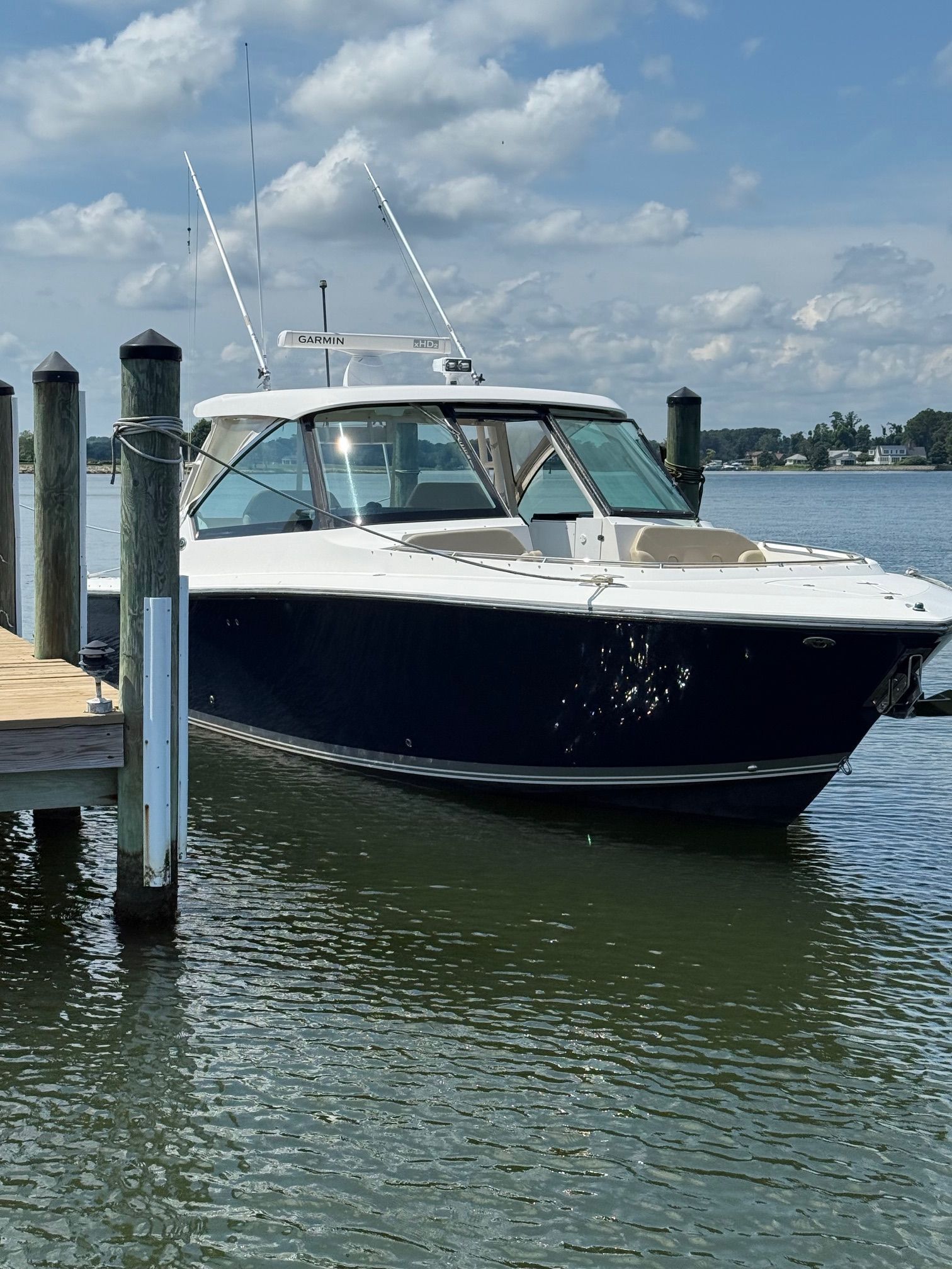A 2016 Pursuit DC 325 Dual Console boat docked on the water.