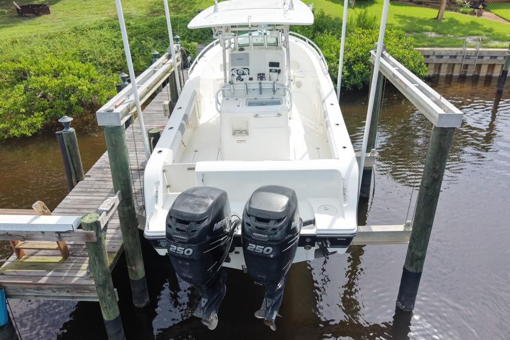 2018 Mako 284 Center Console boat with twin 250 horsepower engines docked.