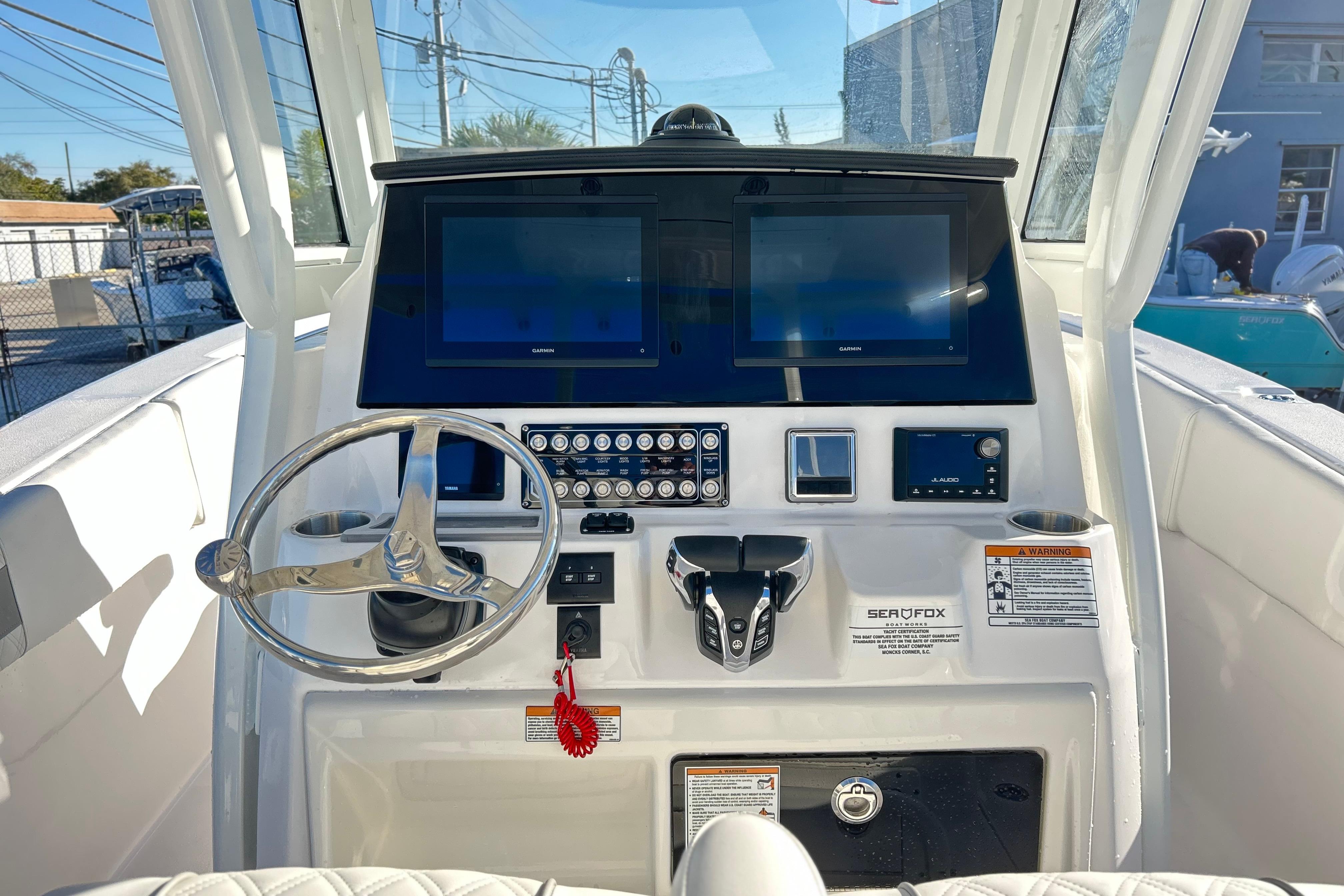 2026 Sea Fox 288 Commander boat dashboard with dual screens and steering wheel.