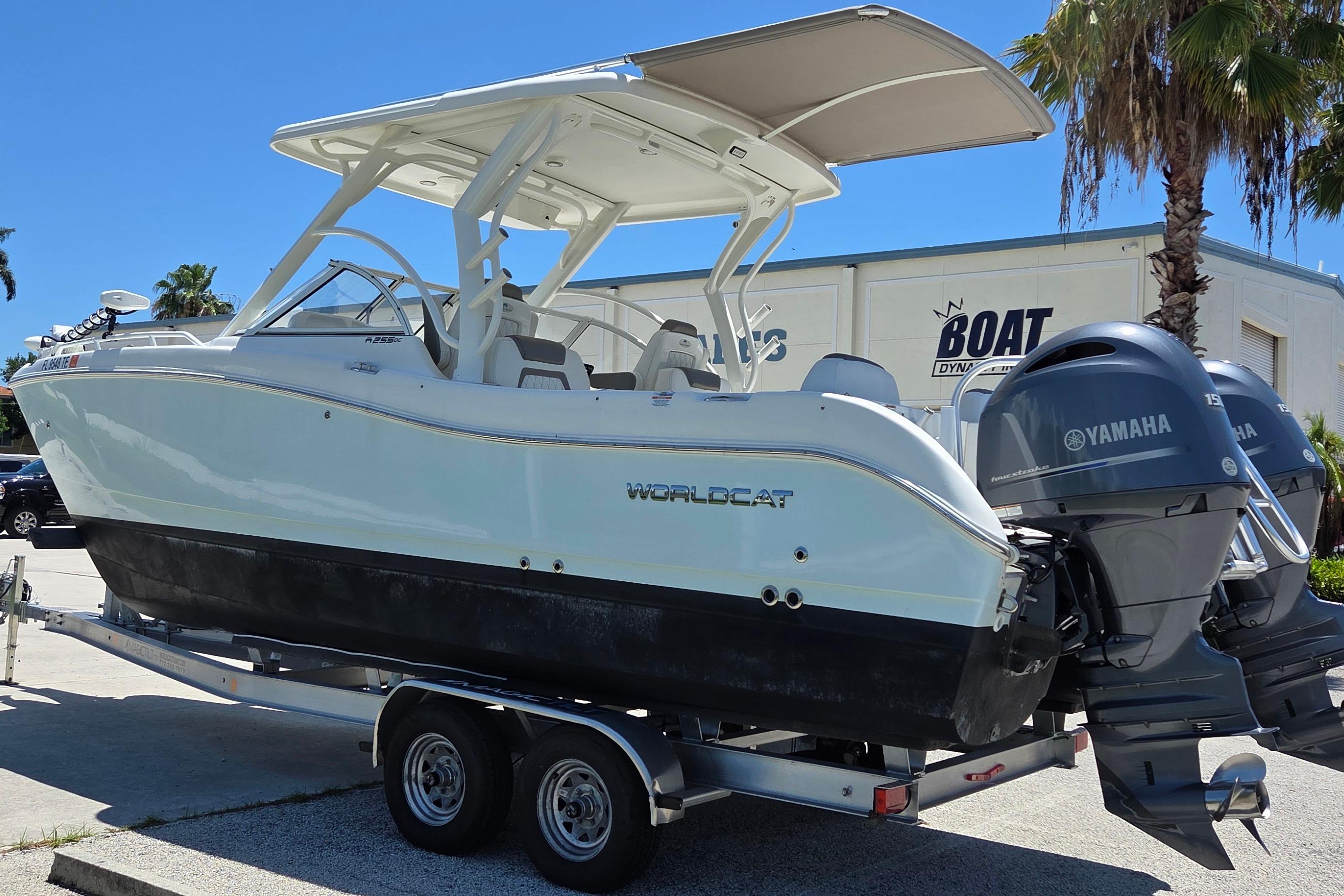 2022 World Cat 255 DC boat on trailer with Yamaha engines, parked outdoors.