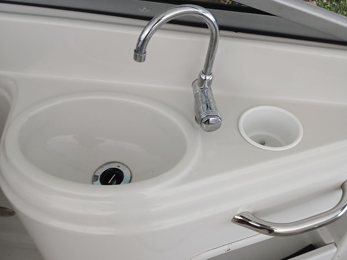 Close-up of a sink with a faucet on a boat.