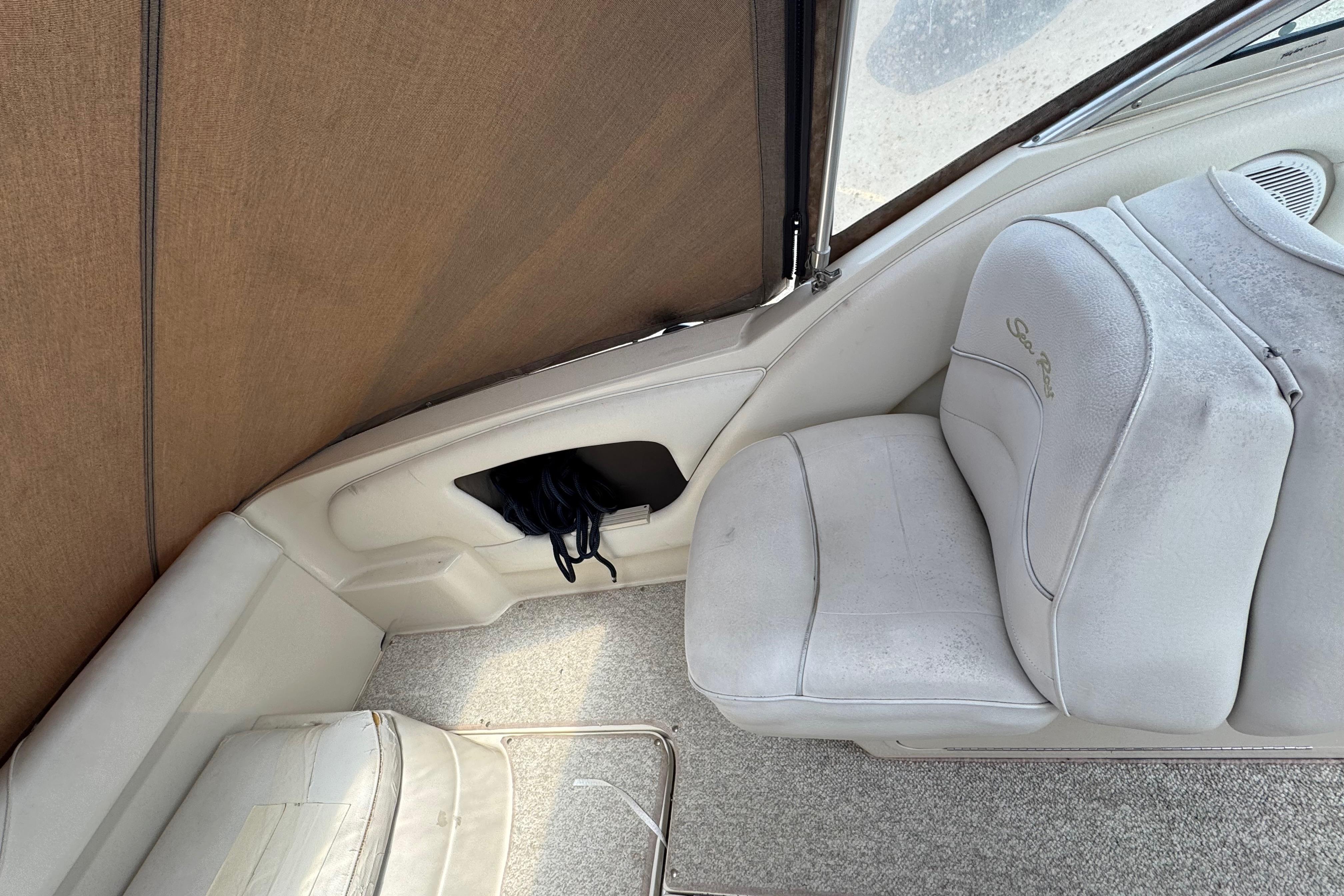 Interior of a 2001 Sea Ray 245 Weekender boat with white seating.