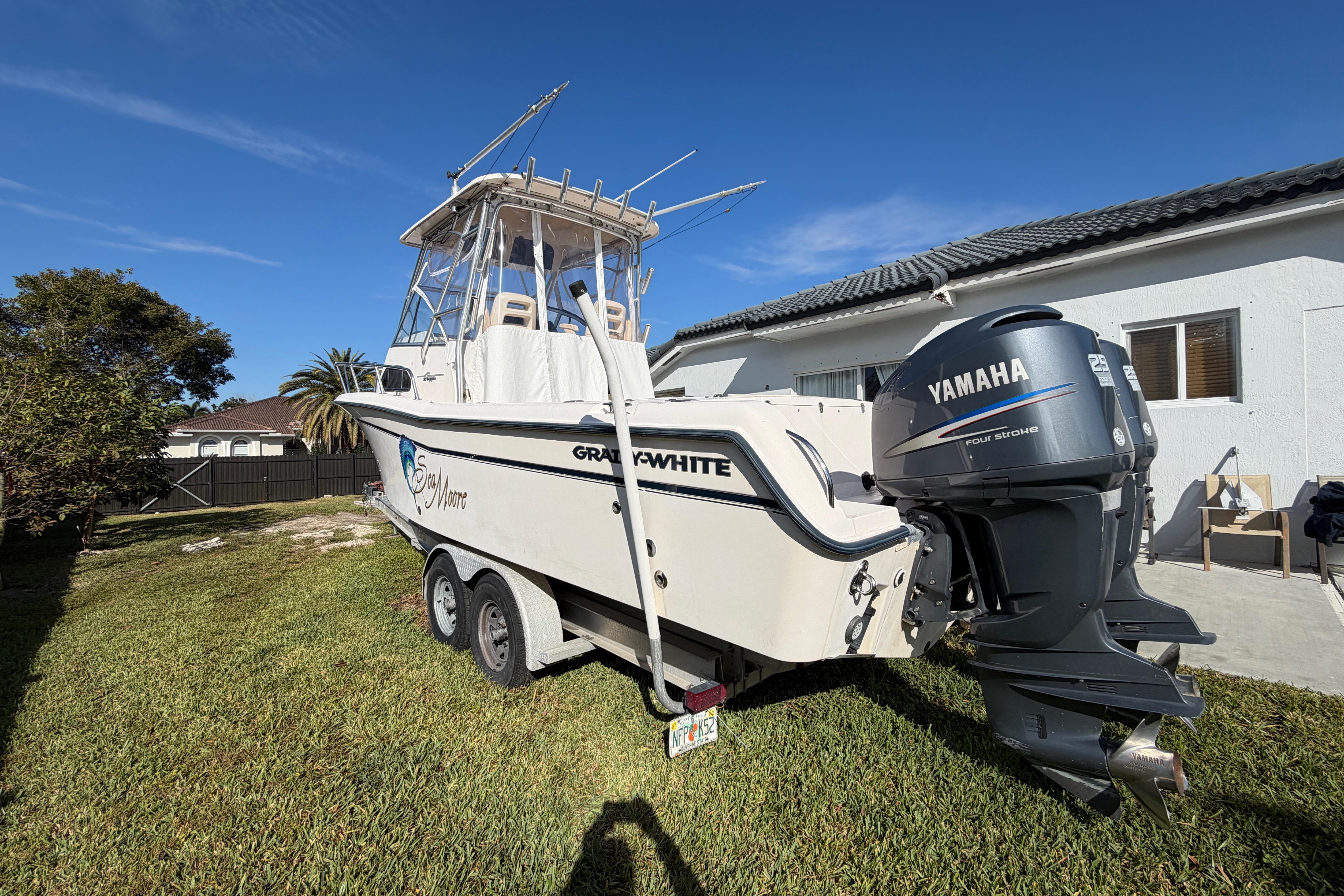 2006 Grady-White Sailfish 282 boat with Yamaha engine on trailer, parked in yard.