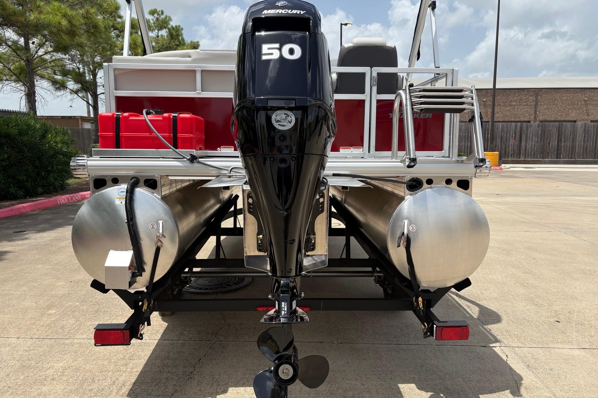 2026 Sun Tracker Bass Buggy 16 XL Select pontoon boat with Mercury 50 engine, rear view.