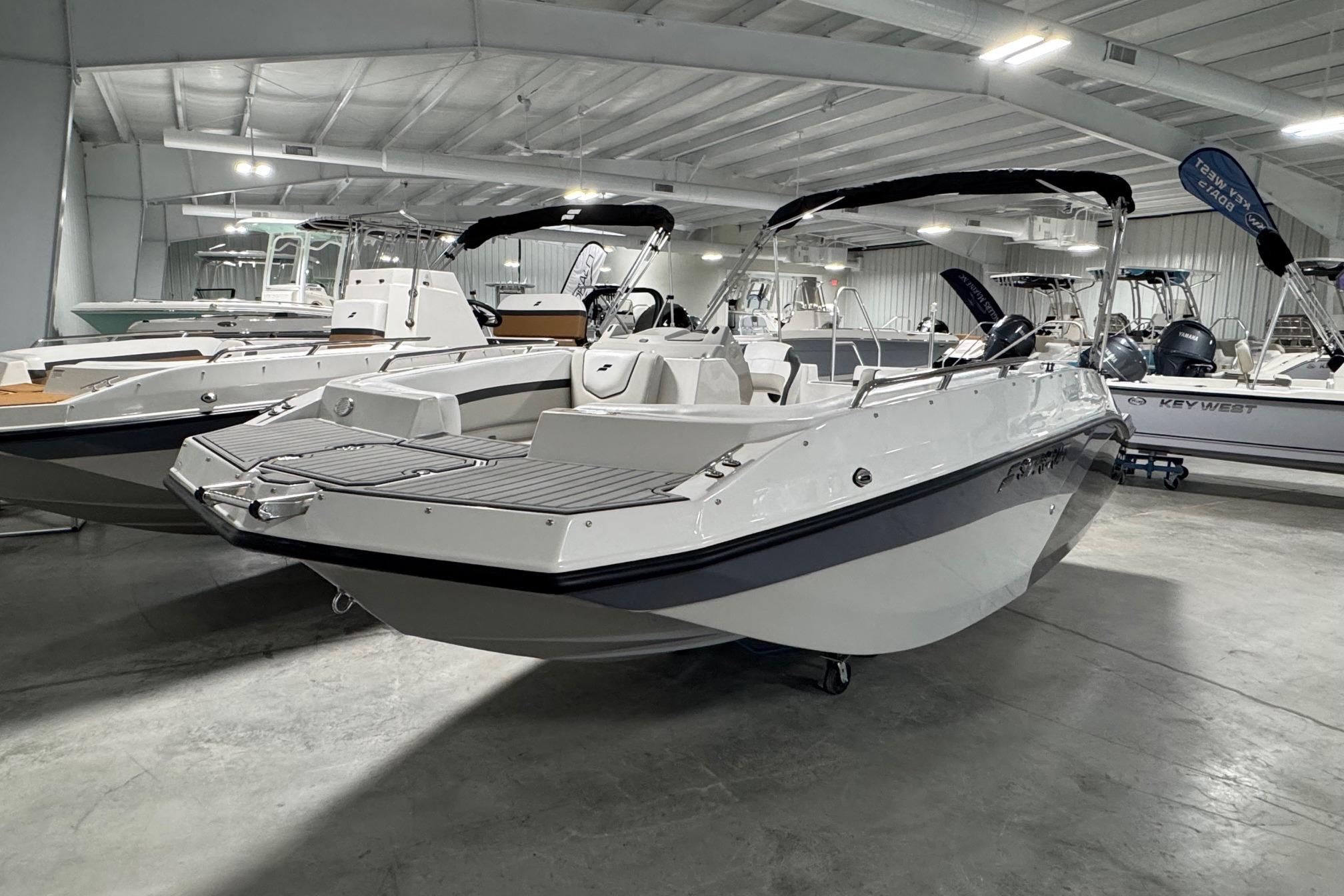 2026 Starcraft SVX 191 OB boat displayed in a showroom, showcasing sleek design and modern features.