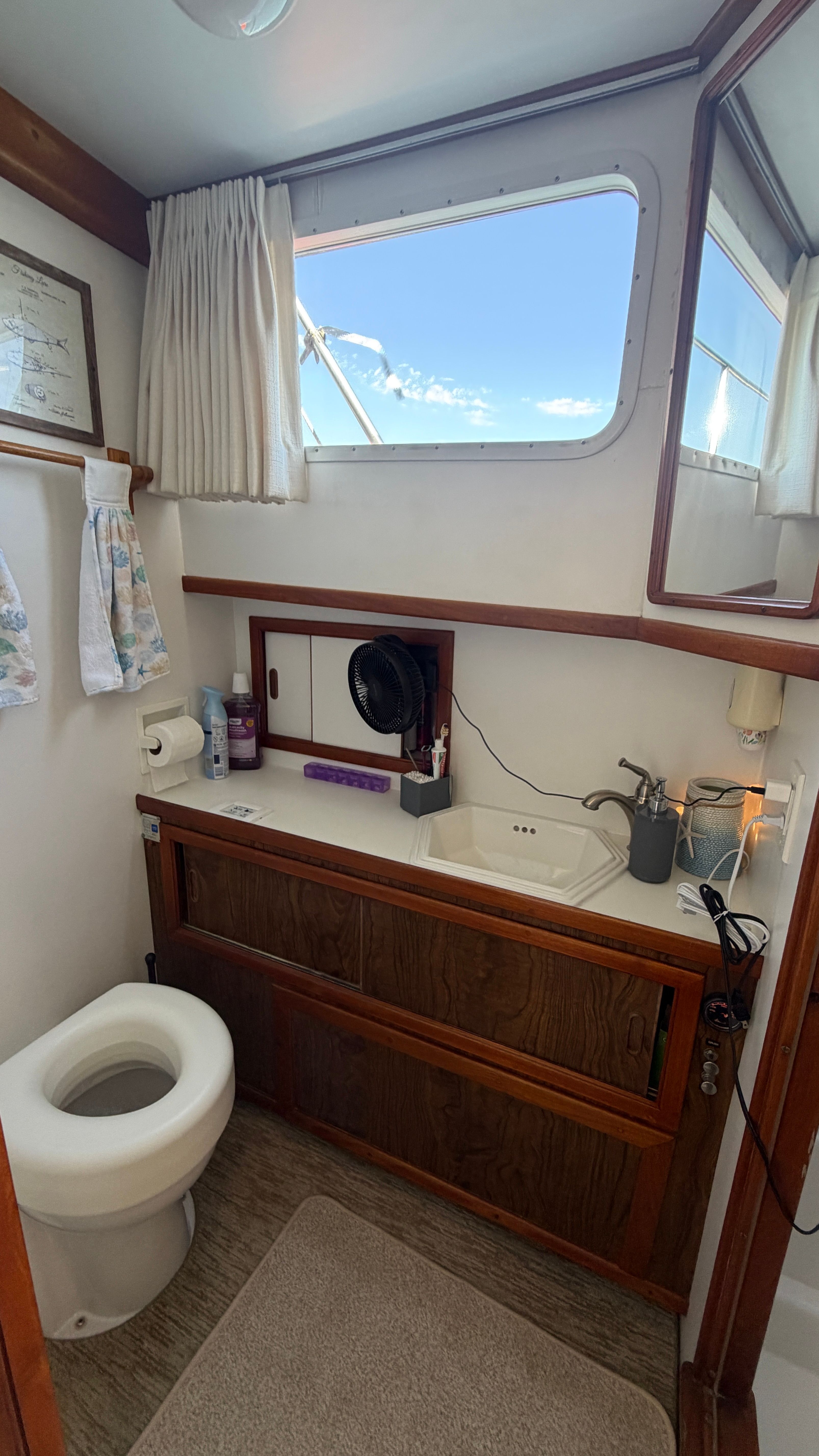 Bathroom on a 1966 Drake Yachtfisher with window view.