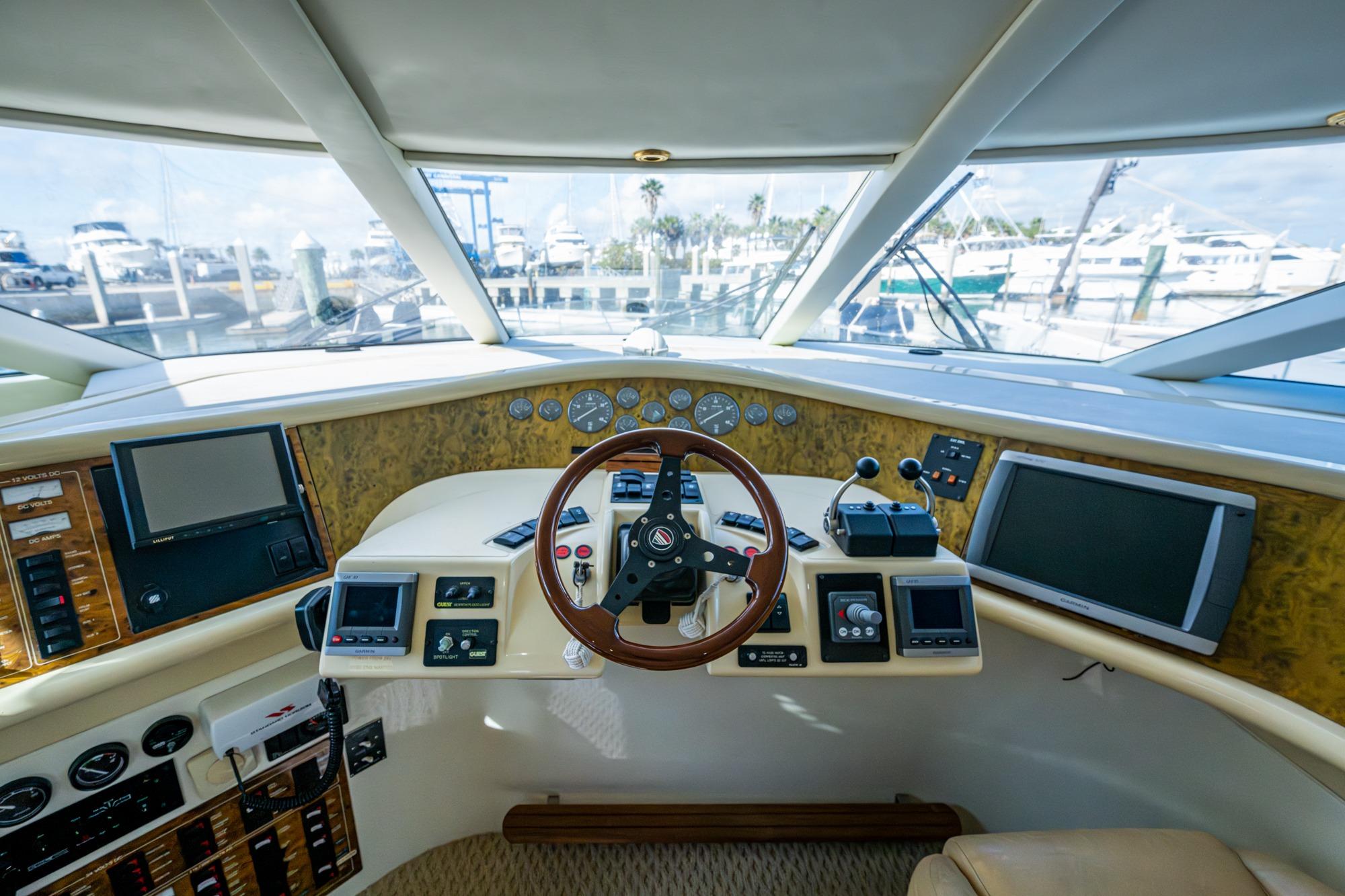 Helm of 2000 Fairline Squadron 52 yacht with navigation instruments and steering wheel.