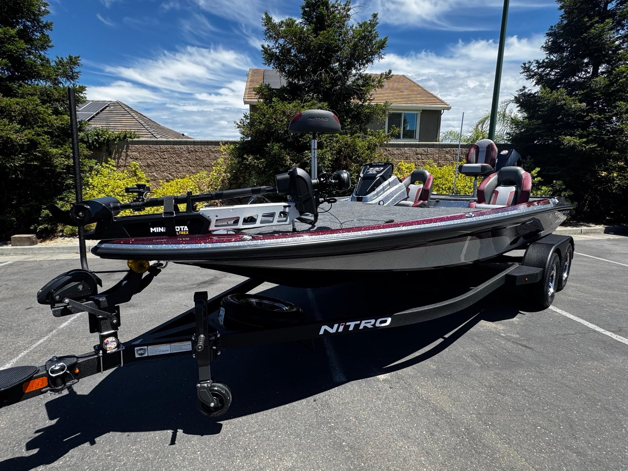 2025 Nitro Z20 XL Pro boat on trailer, parked outdoors under clear sky.