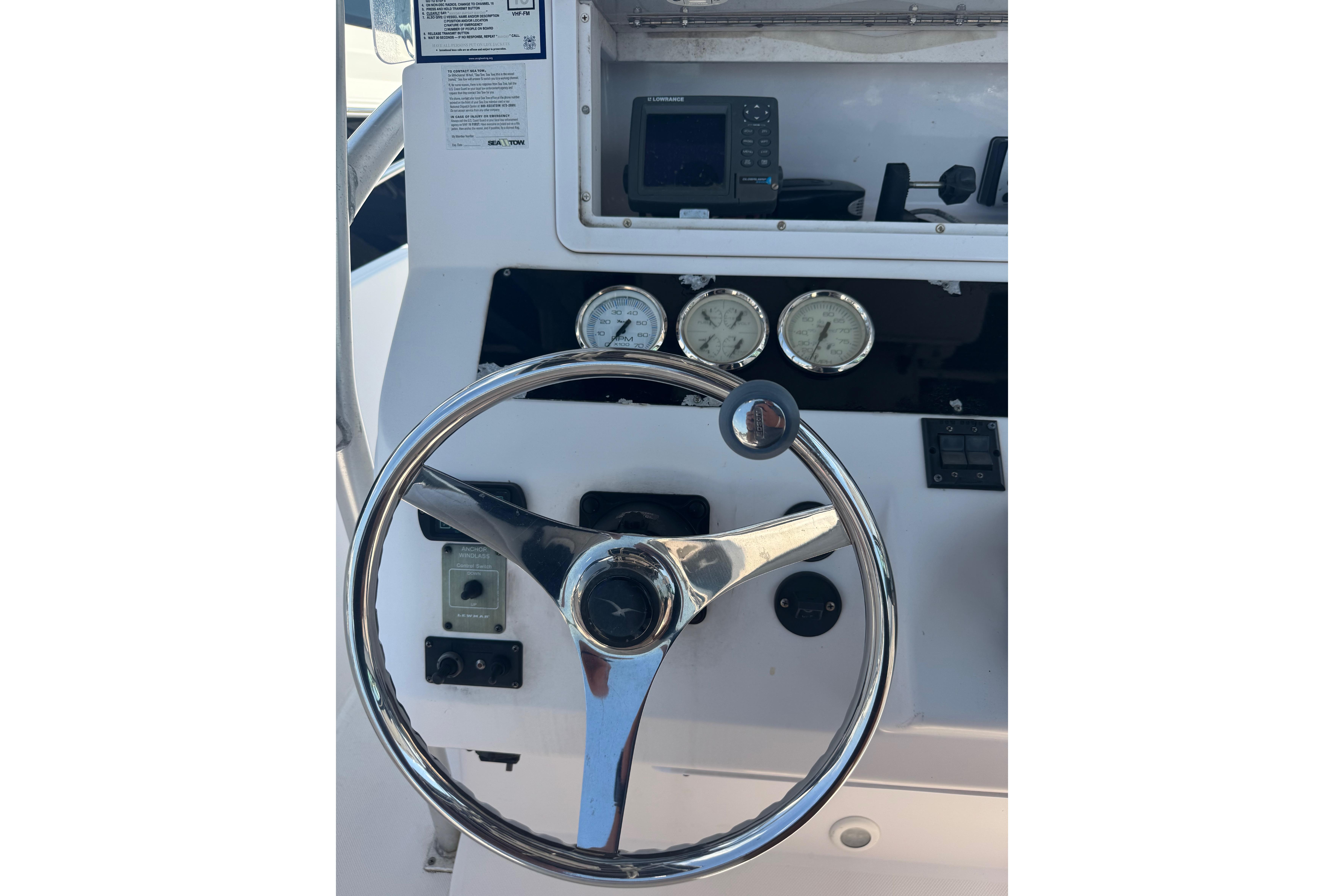 Steering wheel and dashboard of a 2002 Pro-Line 23 Sport boat.