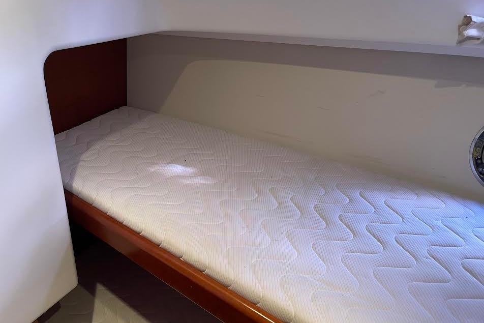 Cozy cabin bed in 2012 Beneteau Swift Trawler 34 yacht interior.