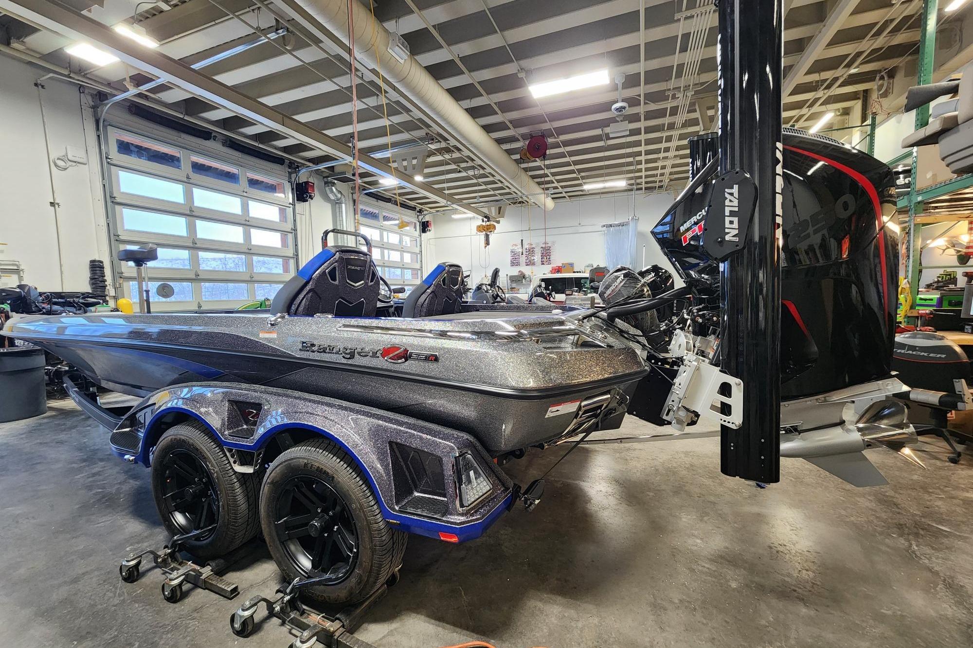 2025 Ranger Z521R boat in a garage, featuring dual axles and a powerful Mercury engine.