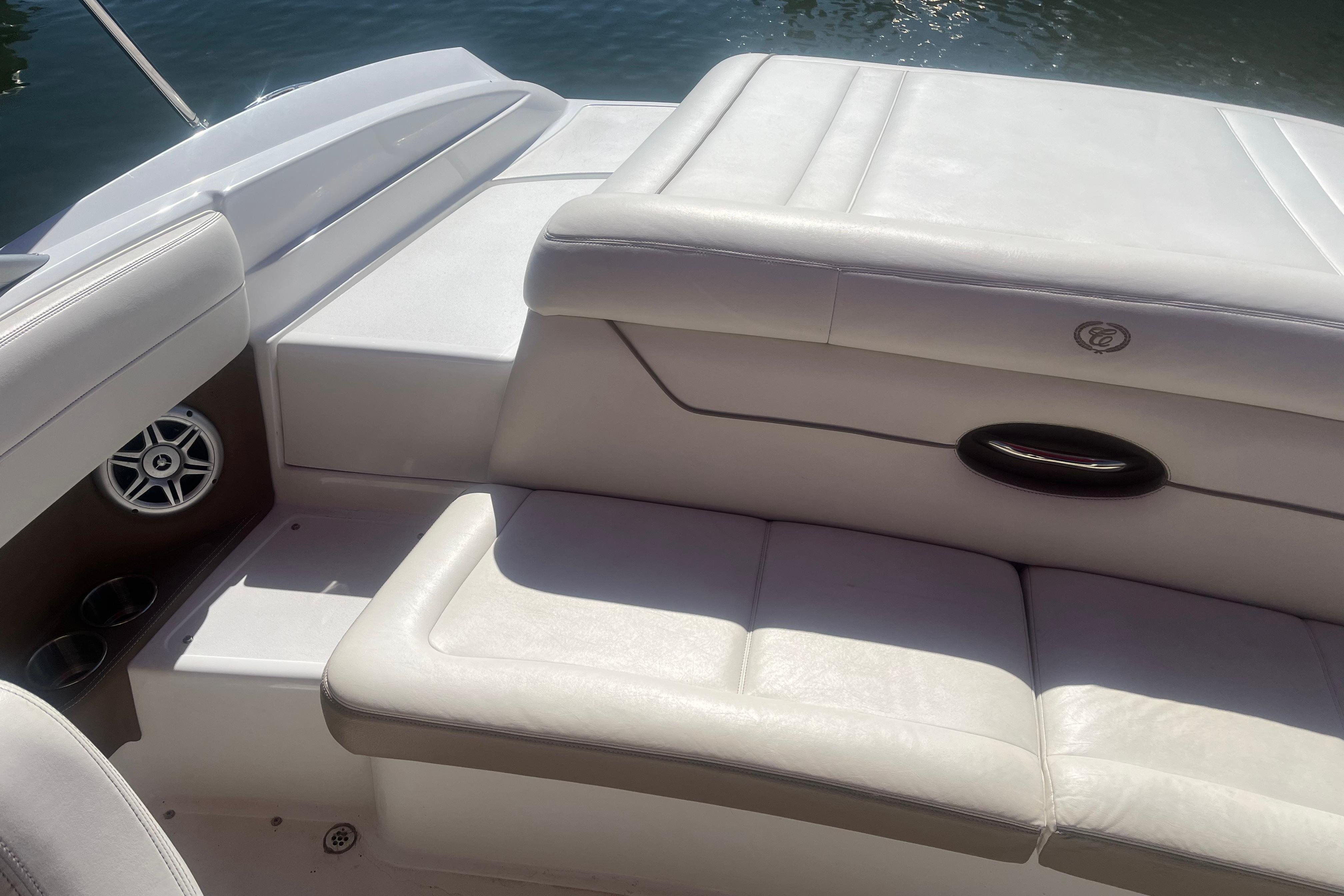 Interior of a 2011 Cobalt 210 boat with white leather seating.