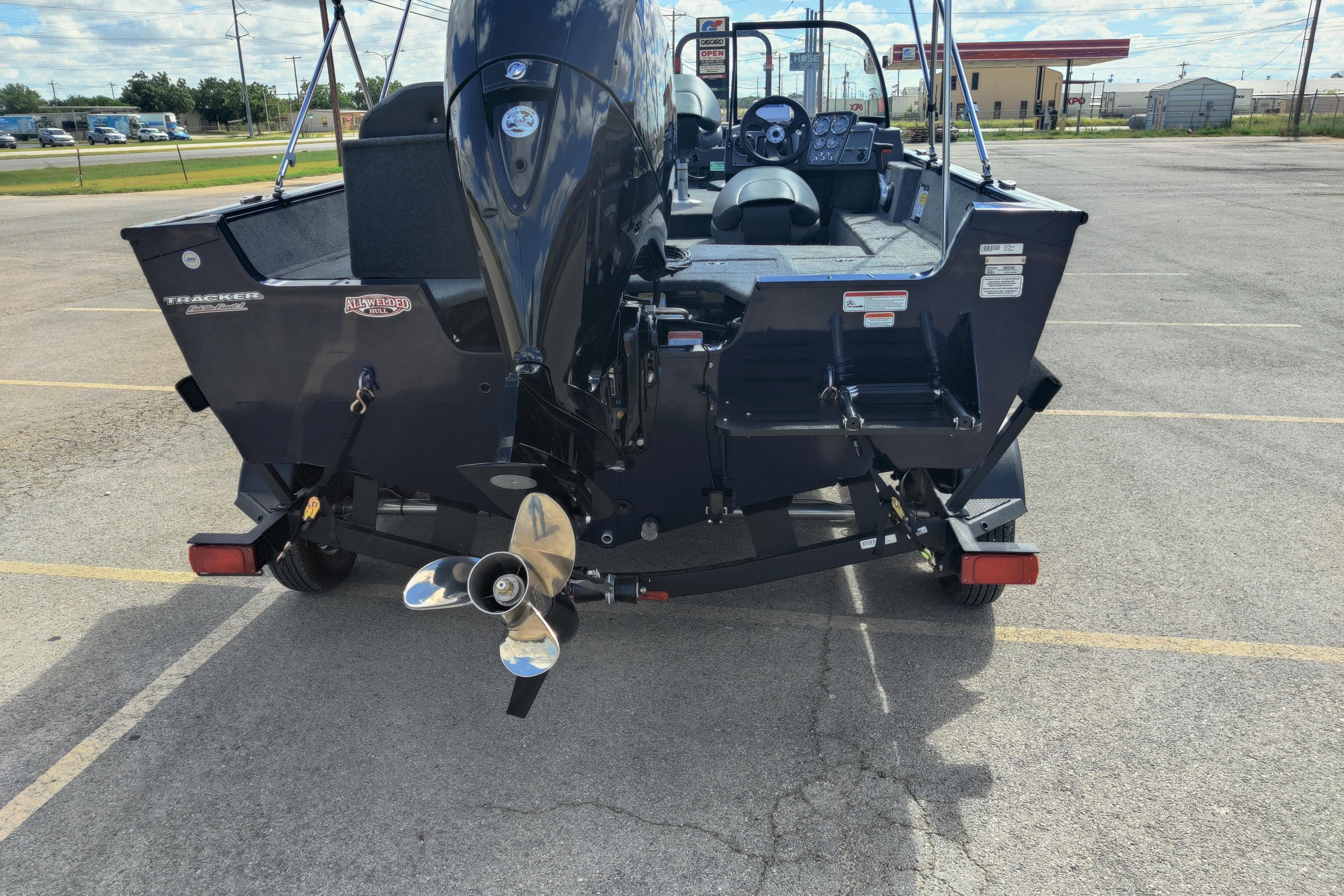 2026 Tracker Pro Guide V-175 Combo boat, rear view with motor, parked in a lot.