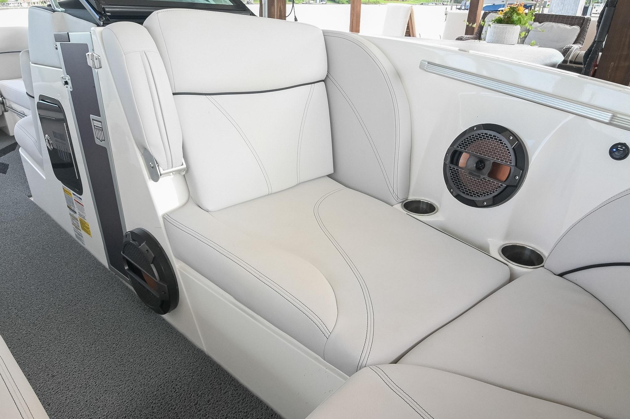 2018 MasterCraft X23 boat interior with white seating and built-in speaker system.
