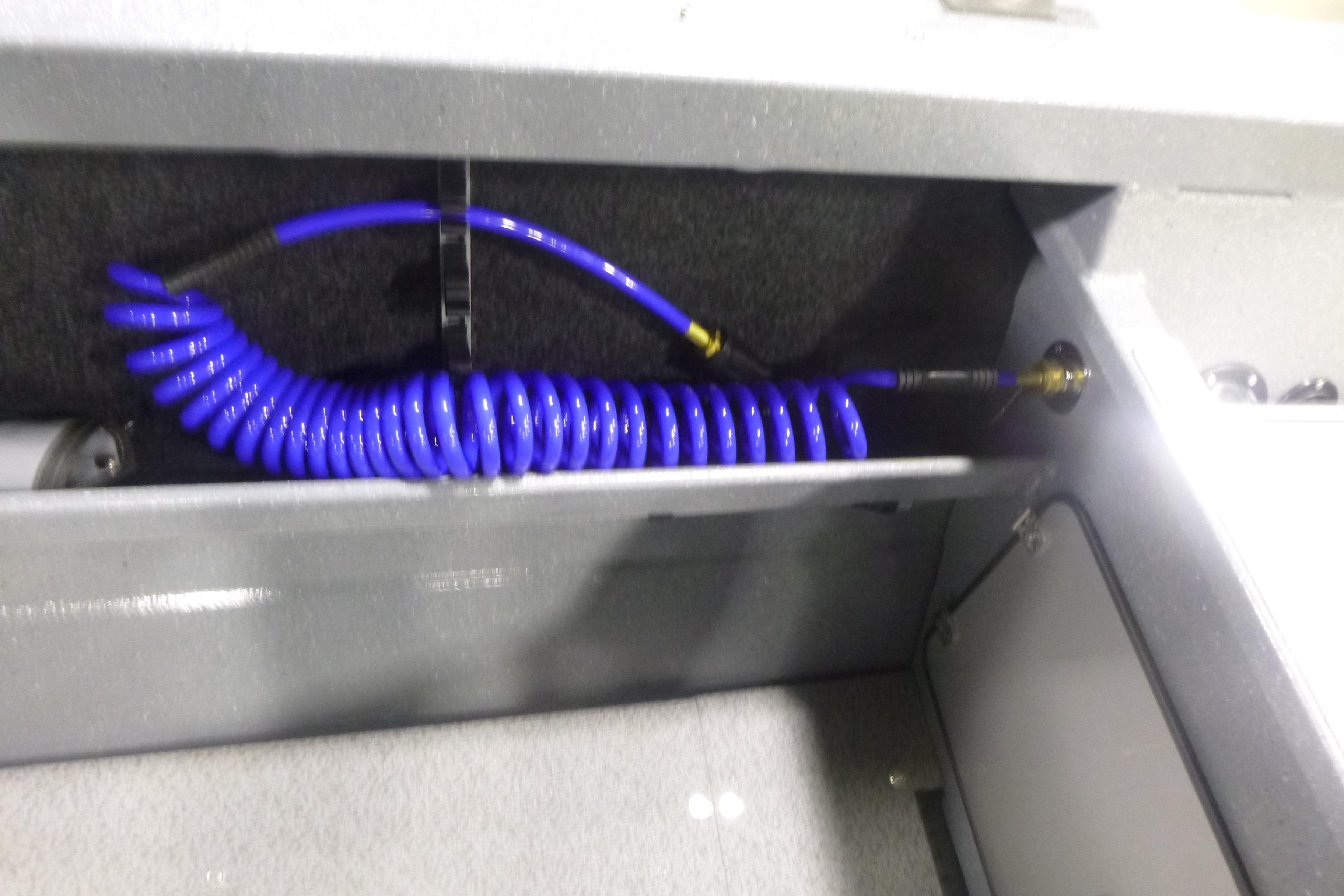 Coiled blue hose in KingFisher 2025 Falcon boat storage compartment, 2026 model.