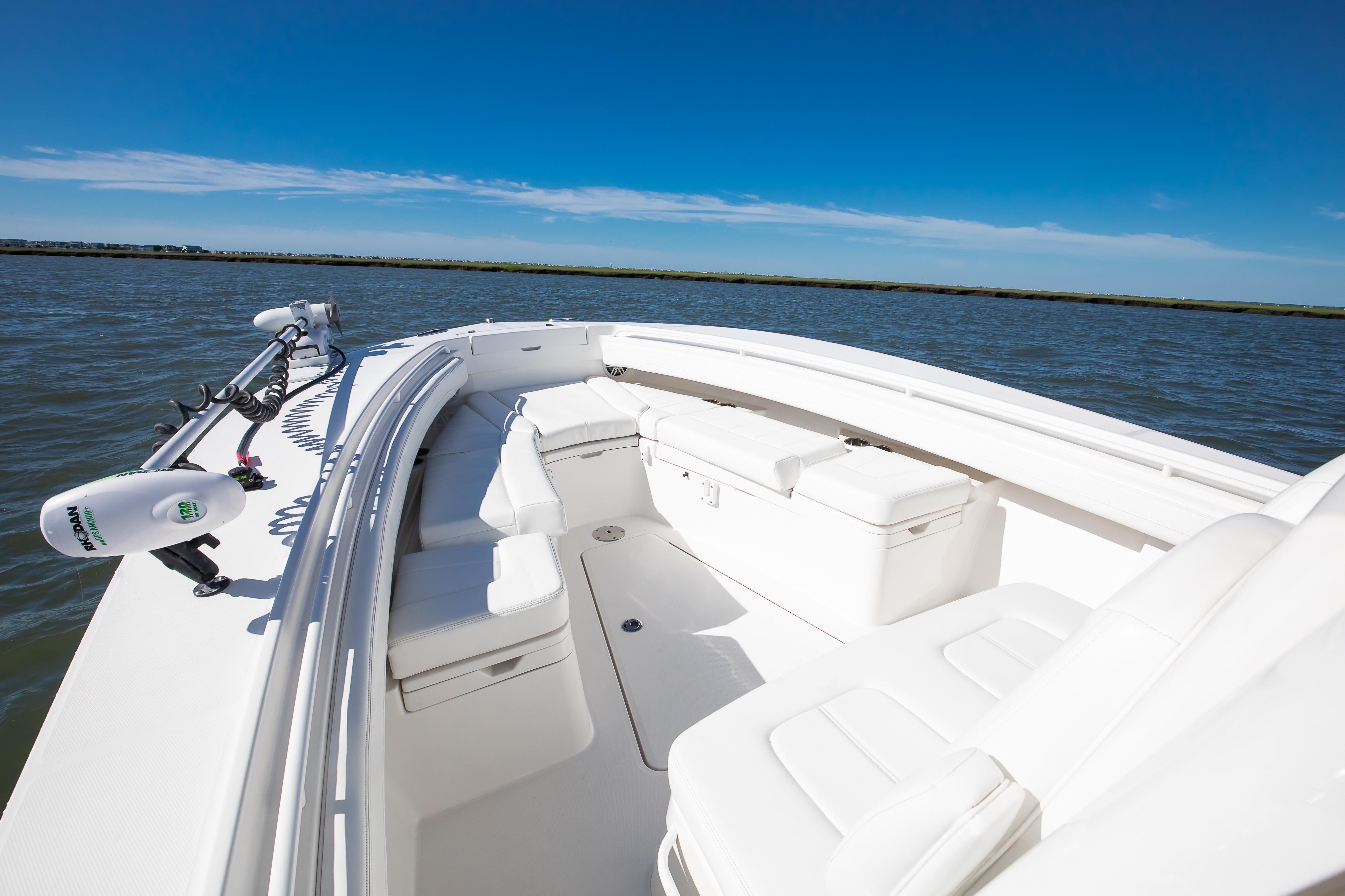2022 Regulator 28 Forward Seating boat on calm water under clear blue sky.