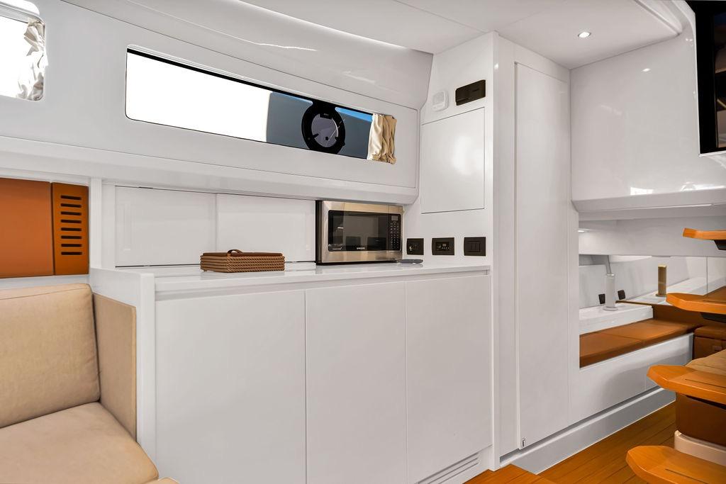 Modern interior of 2021 Bluegame BG 42 yacht with sleek kitchen and seating area.