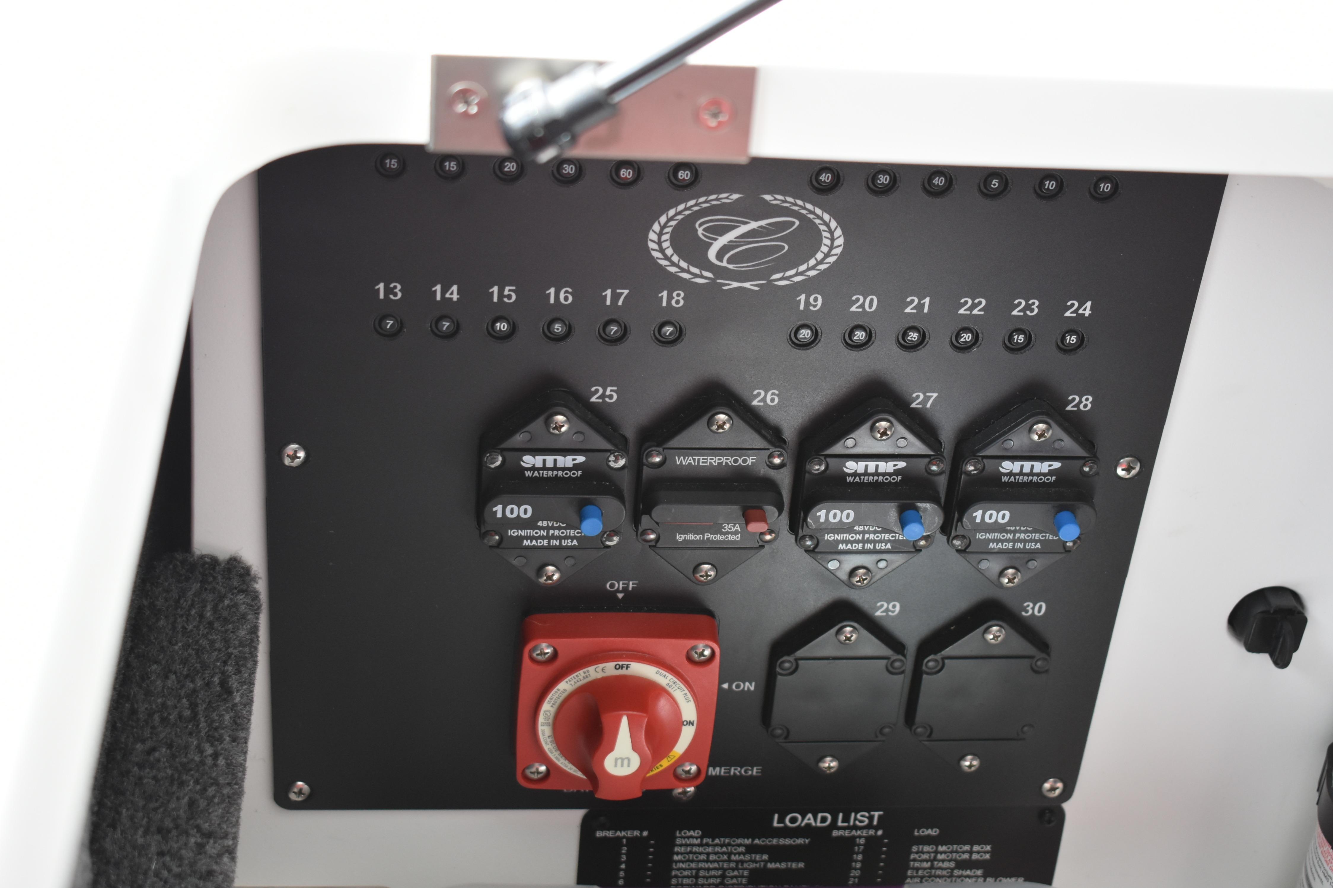 Control panel of 2023 Cobalt R8 boat with circuit breakers and switches.