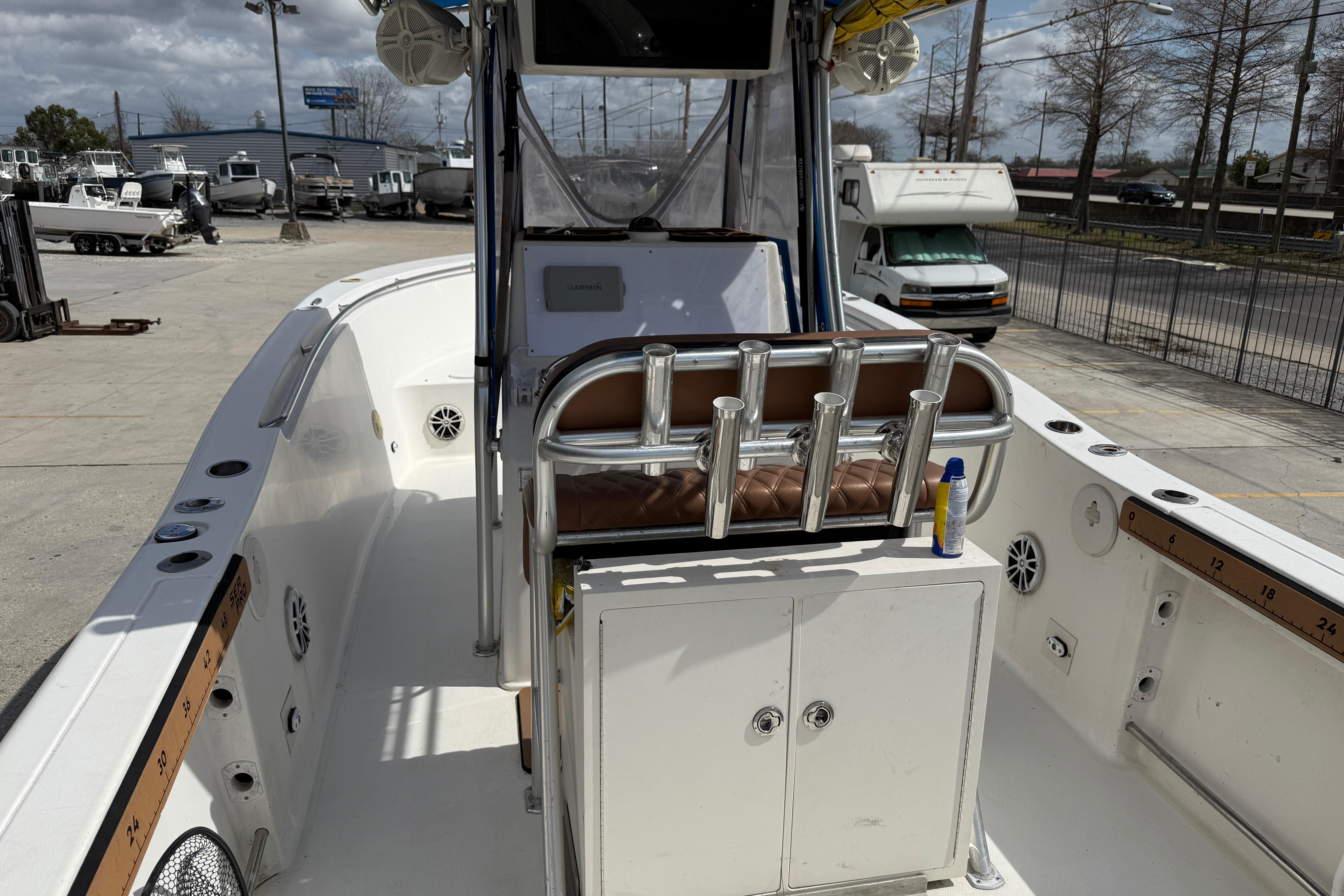 2007 Sea Pro 270 Center Console boat interior with rod holders and storage compartments.