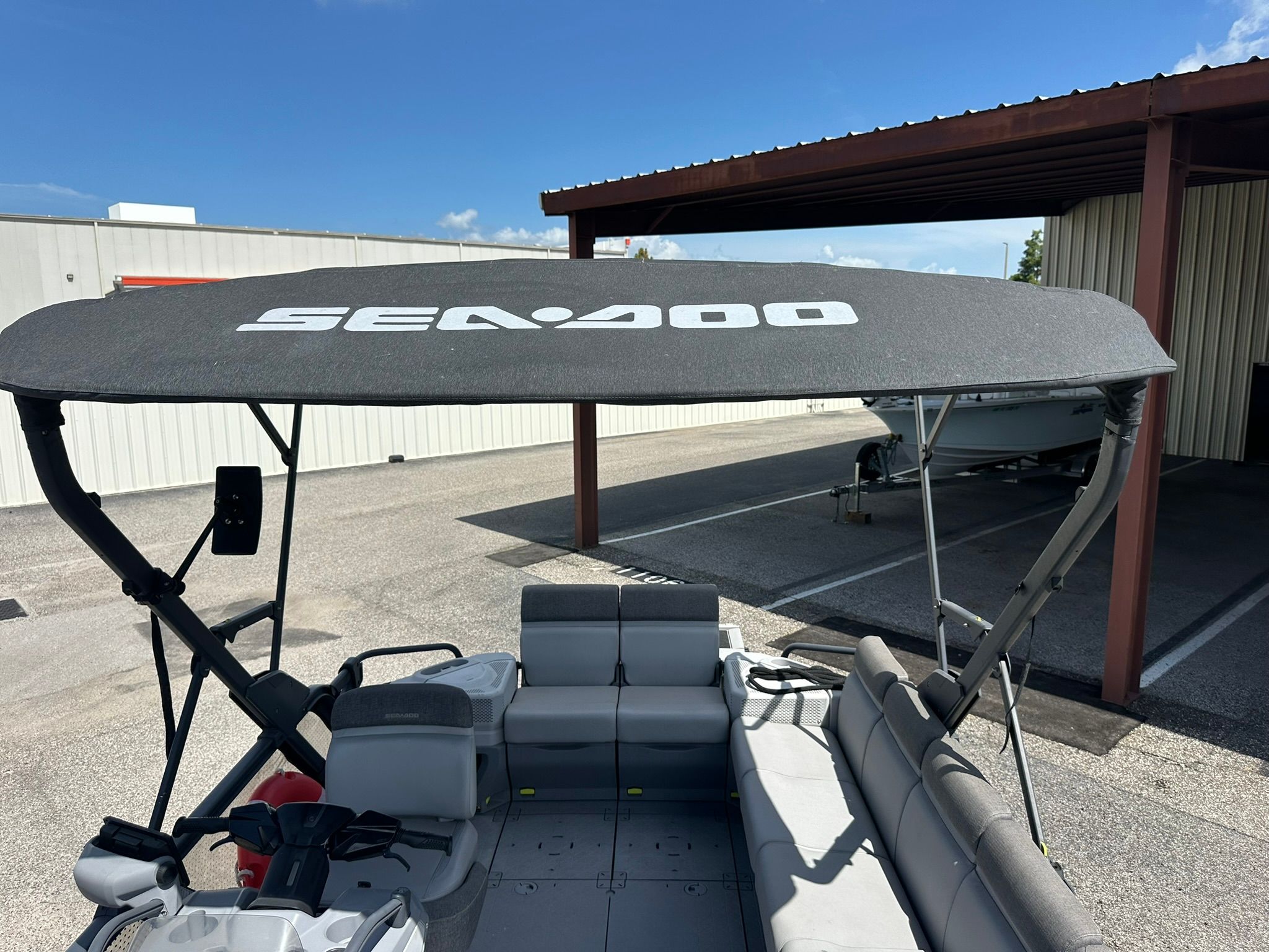 The image shows the deck of a Sea-Doo 21 SWITCH SPORT boat with a sunshade.