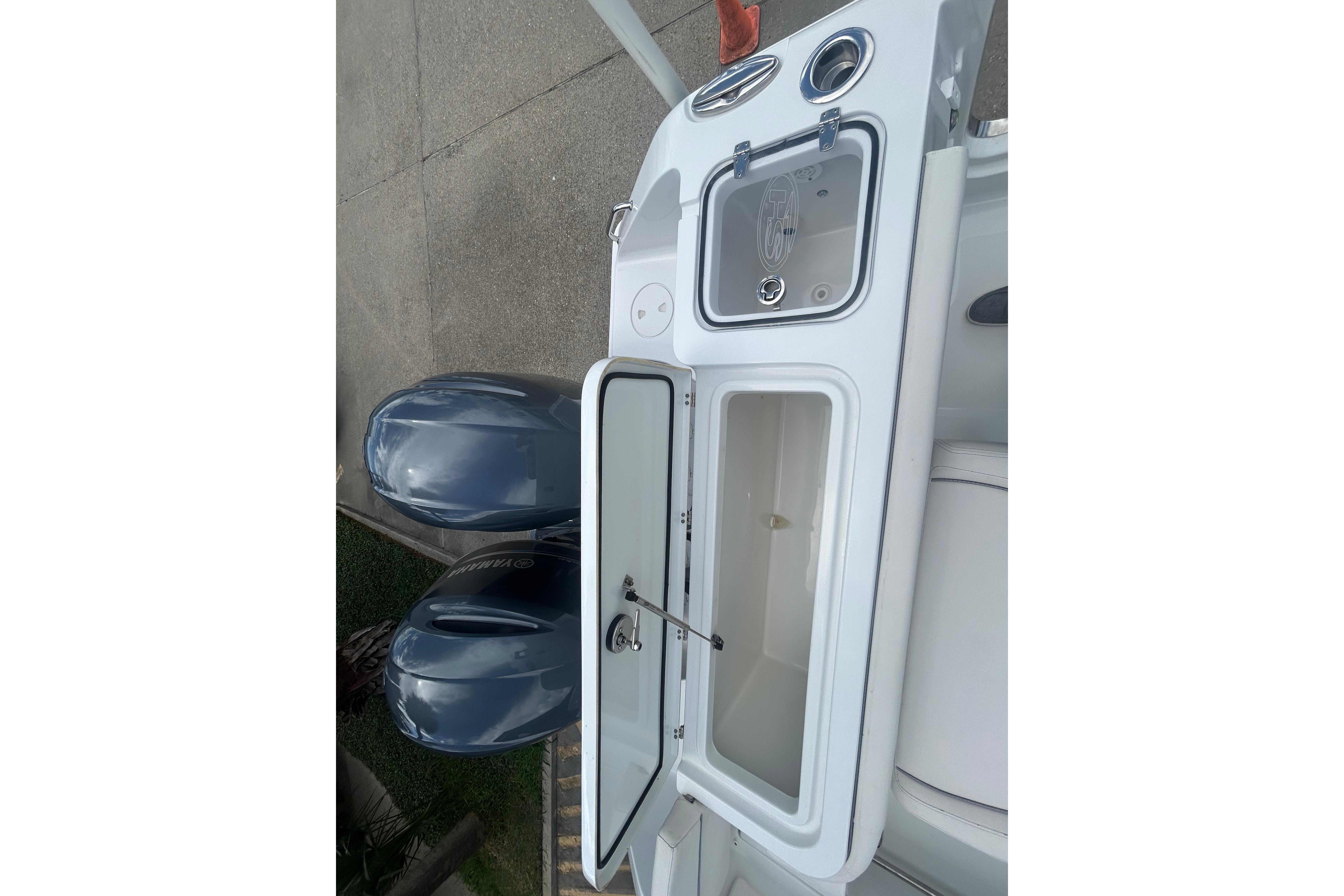 2023 Sea Hunt Gamefish 27 Coffin Box with dual outboard motors and open storage compartments.
