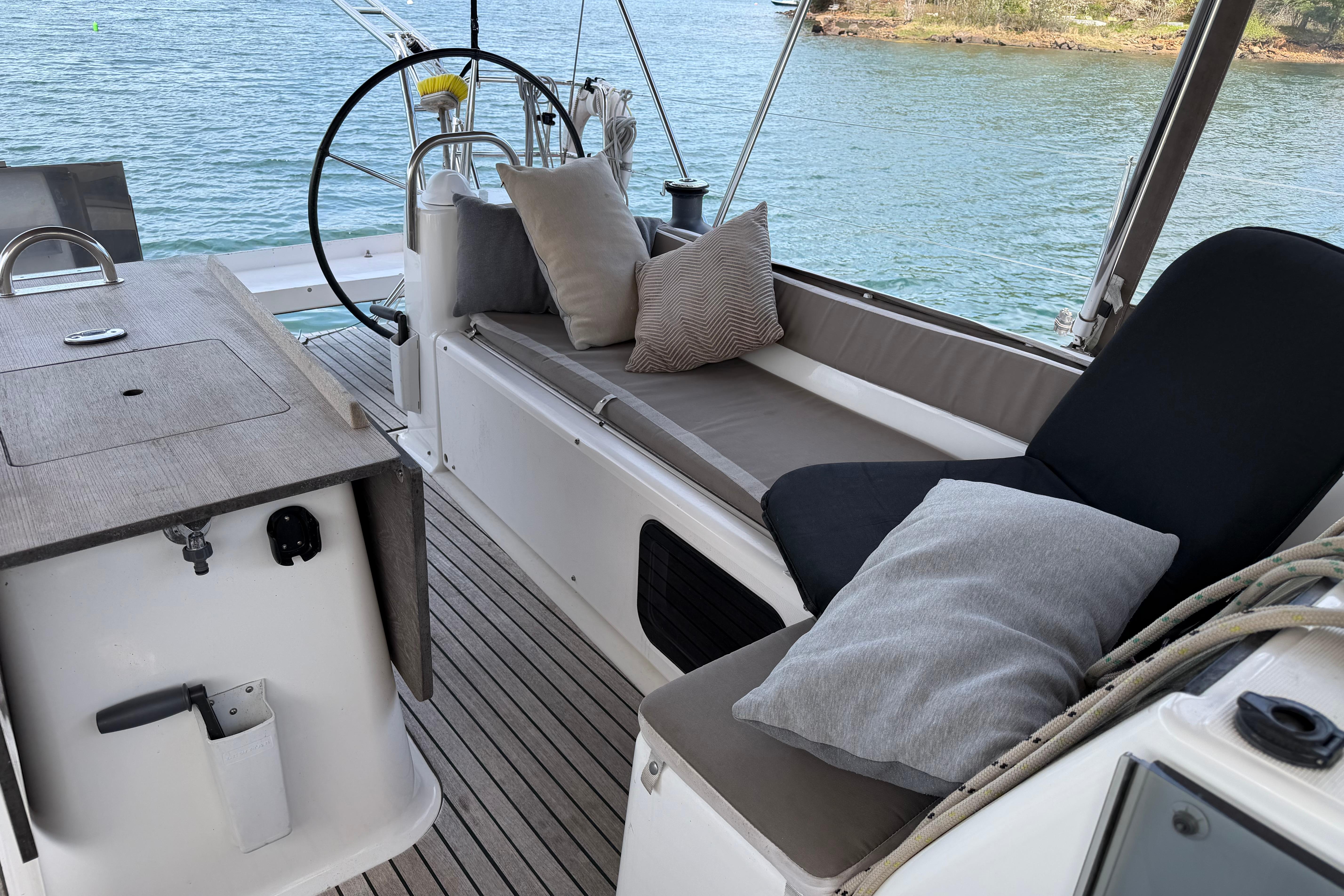 Luxurious 2016 Dufour 512 Grand Large yacht interior with comfortable seating and scenic water view.