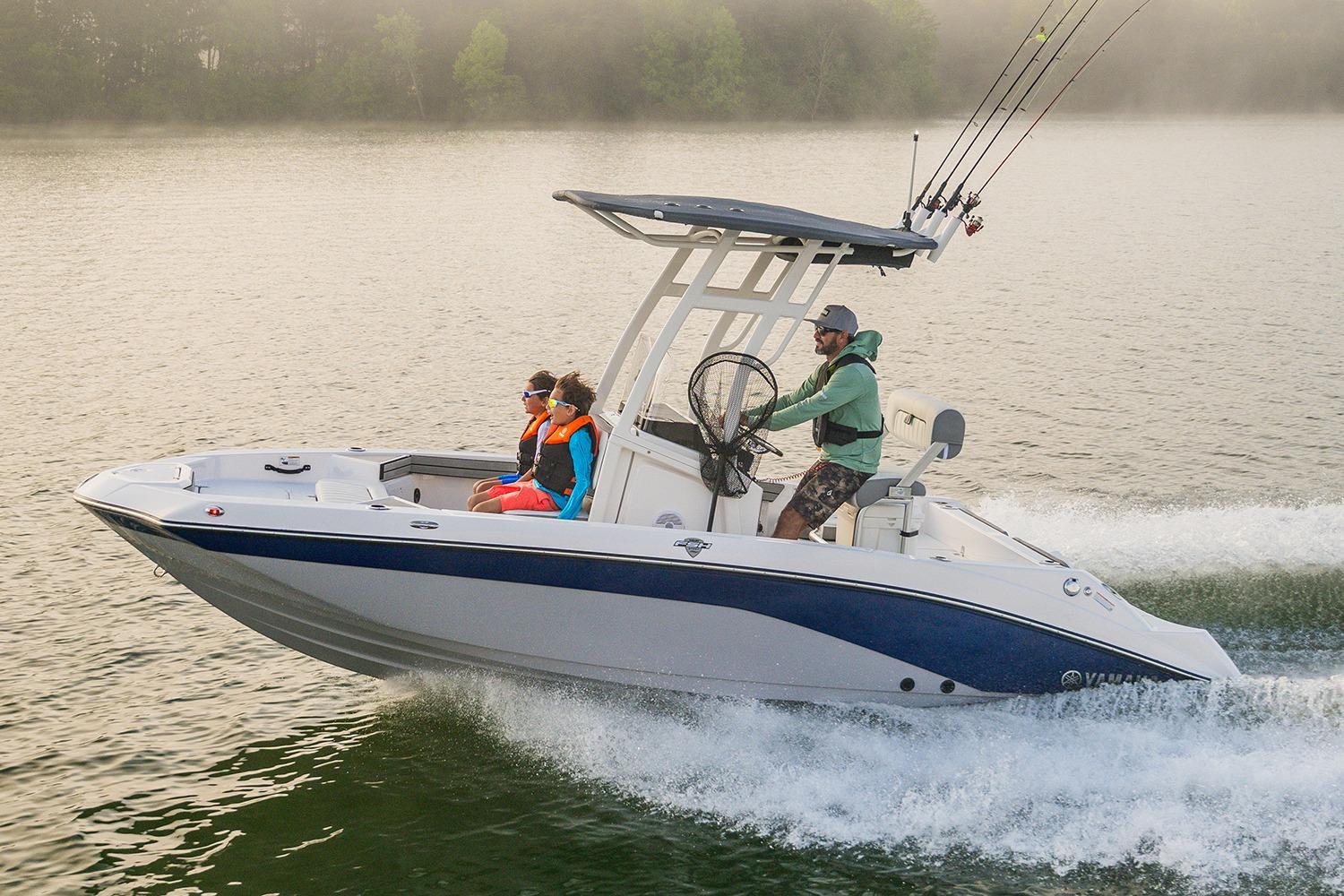 Manufacturer Provided Image: 2026 Yamaha Boats 195 FSH Sport cruising on a serene lake with passengers.