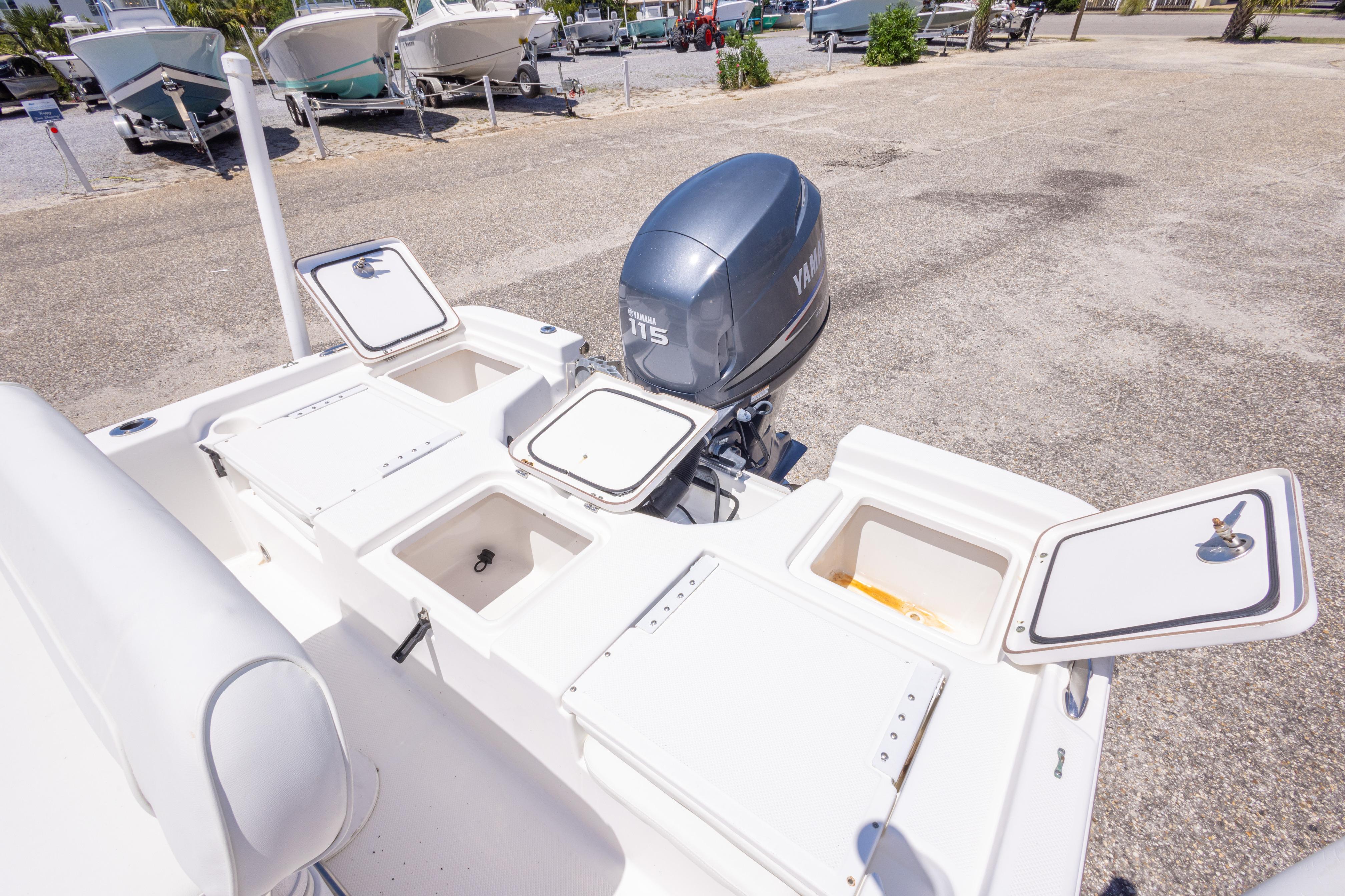 2011 Sea Fox 200XT boat with open storage compartments and Yamaha 115 outboard motor.