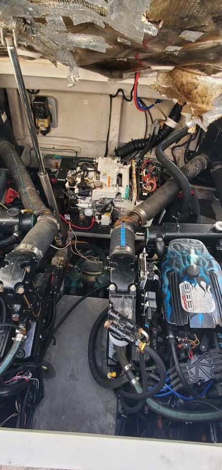 Engine room of a 2002 Wellcraft 3300 Martinique with two engines and wiring.