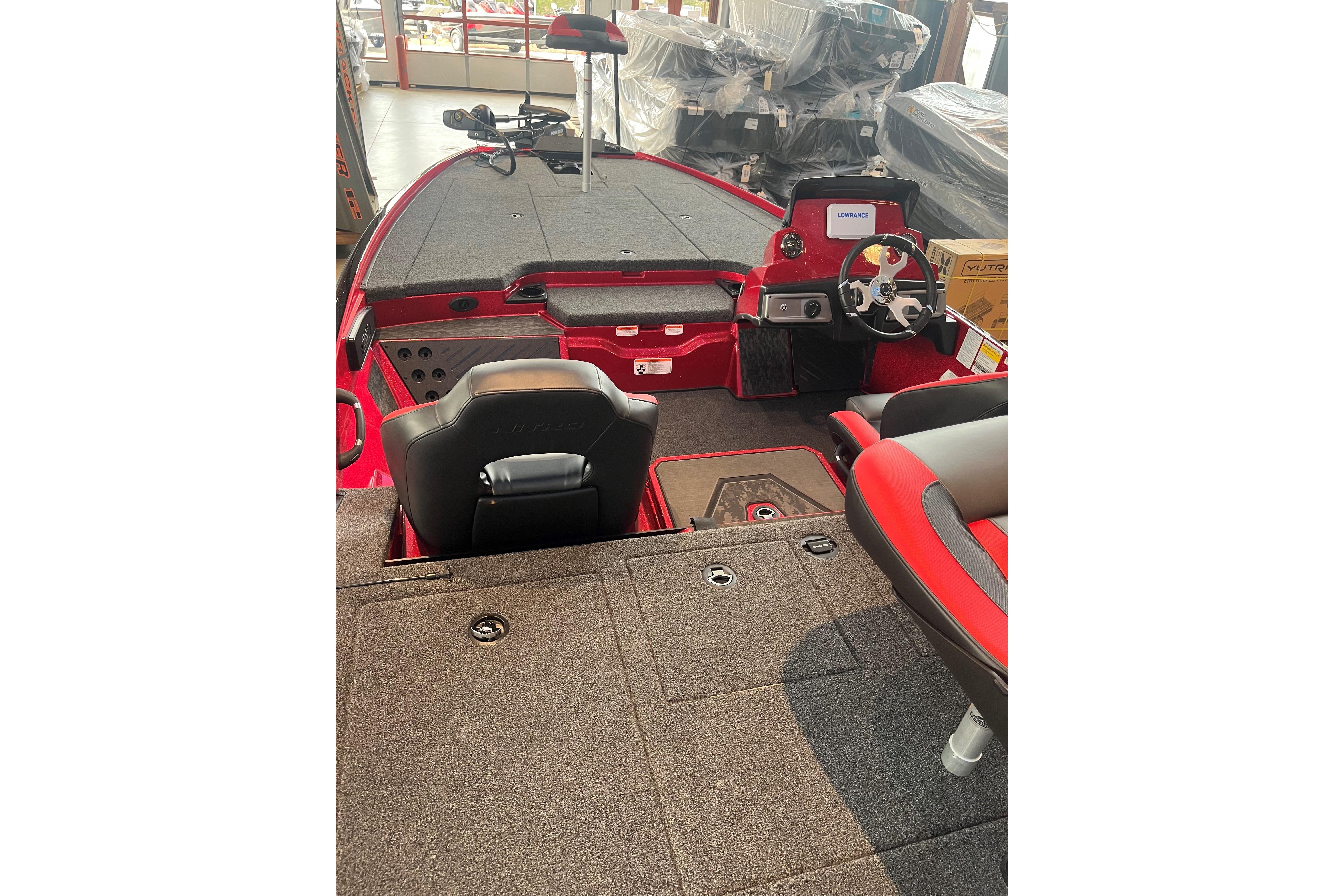 2026 Nitro Z20 XL boat interior with red and black seating, steering console, and spacious deck.