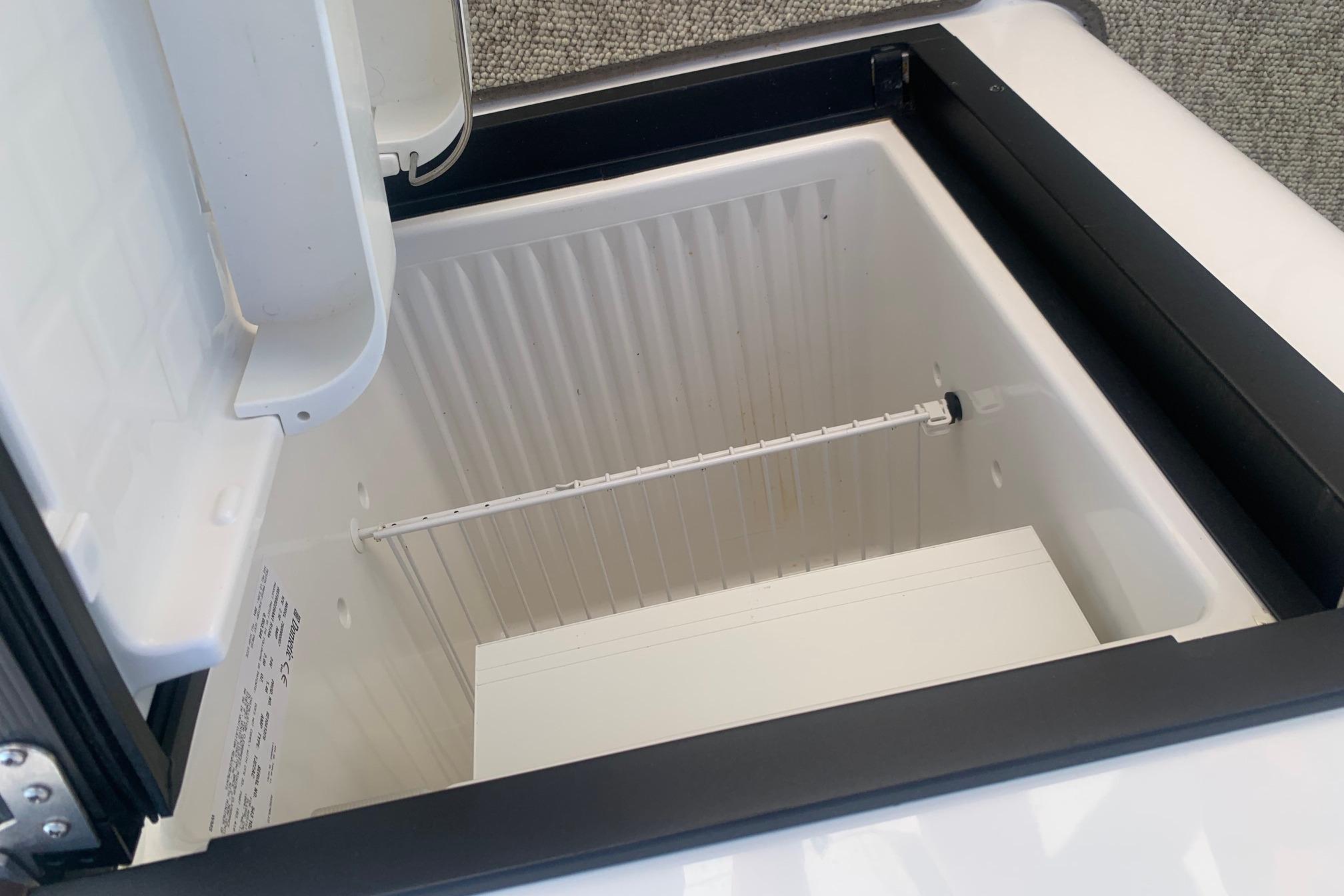 Open storage compartment in 2006 Rinker 282 Captiva Cuddy boat, featuring a clean interior.
