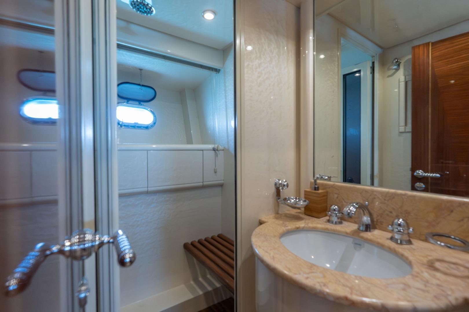 Luxurious bathroom interior on a 2004 Mangusta 72 yacht, featuring elegant fixtures and a marble countertop.