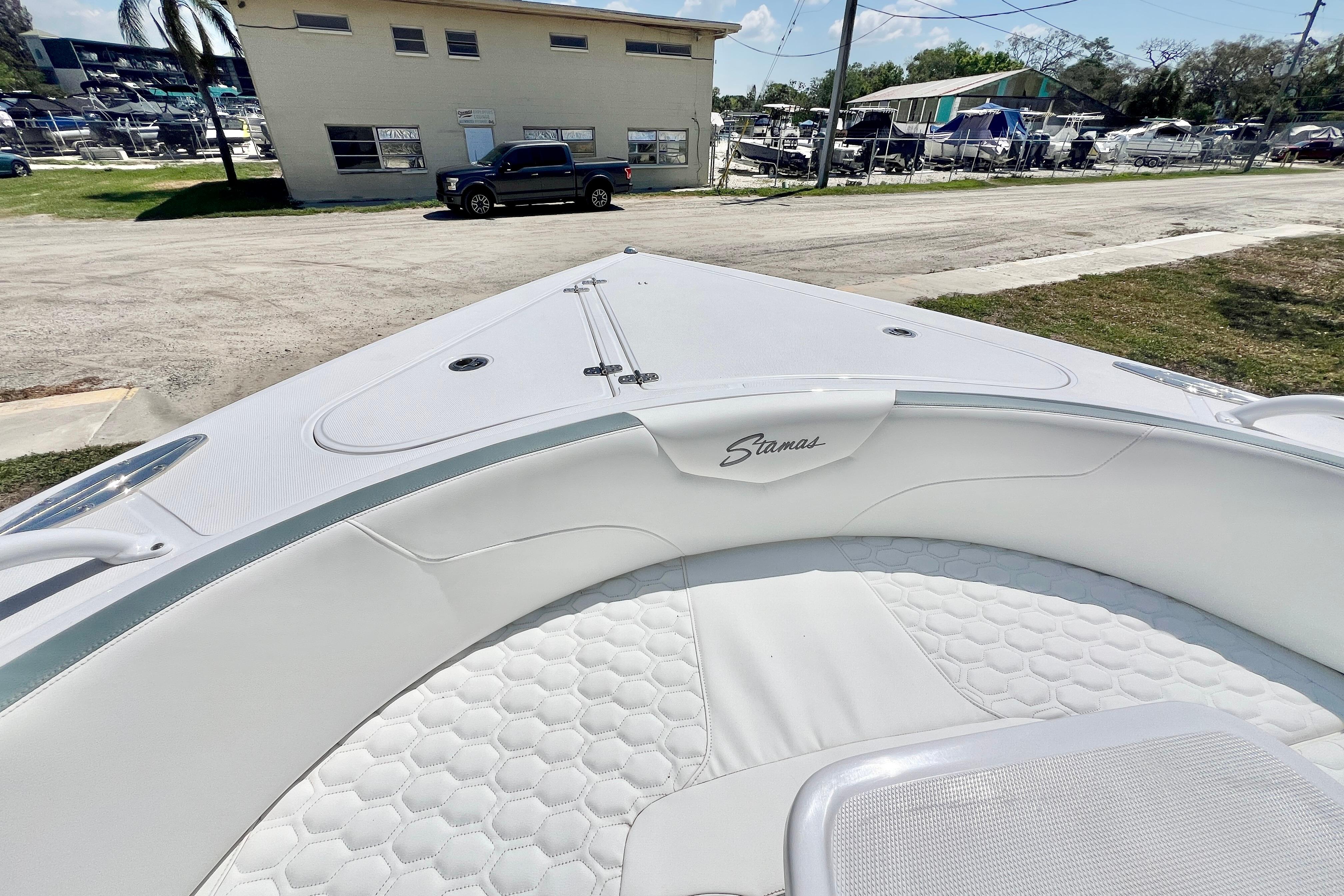 2026 Stamas 31T Aventura boat with white interior, docked near a marina.