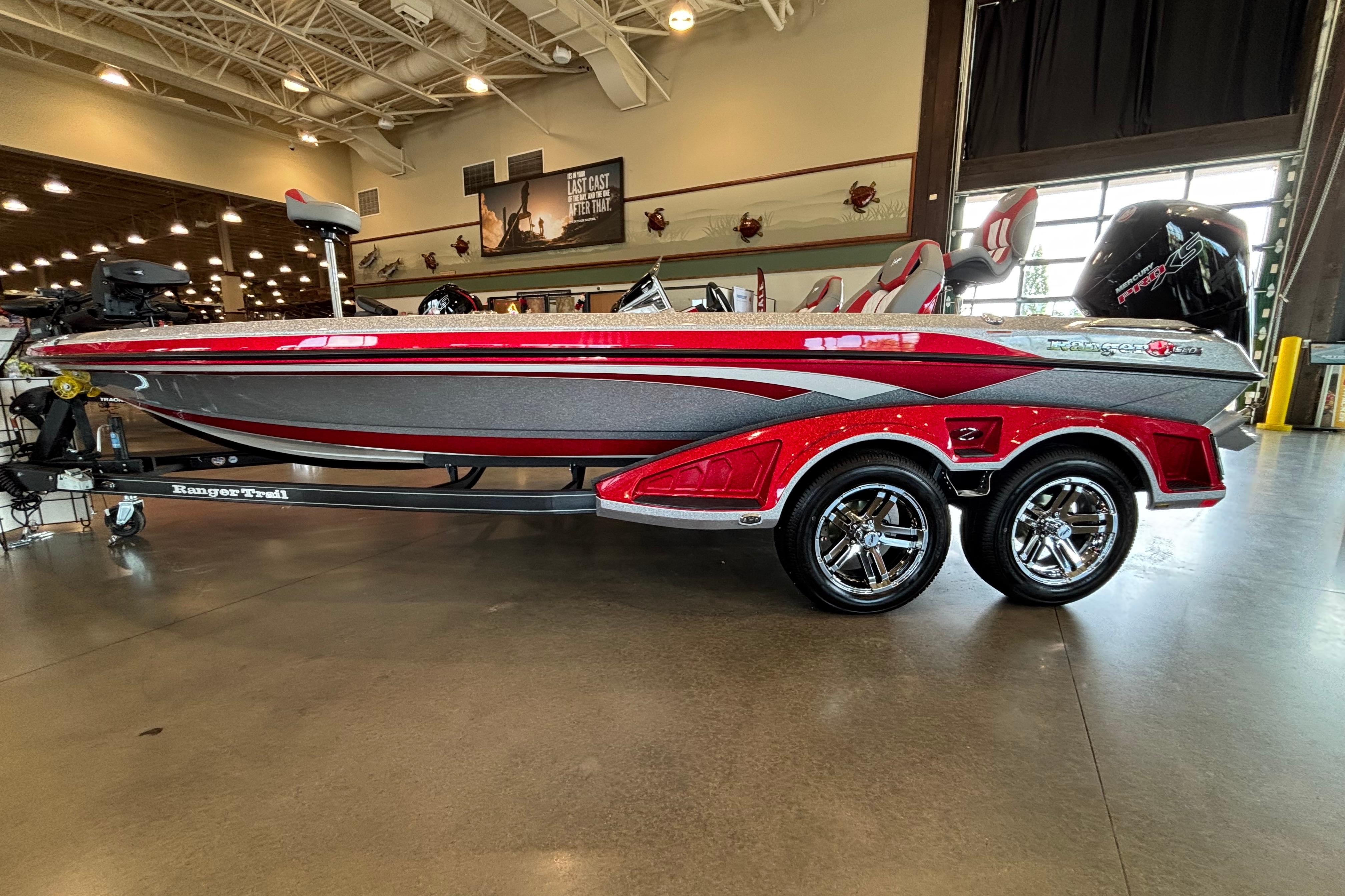 2026 Ranger Z520R Cup-Equipped boat with sleek red and gray design in showroom.