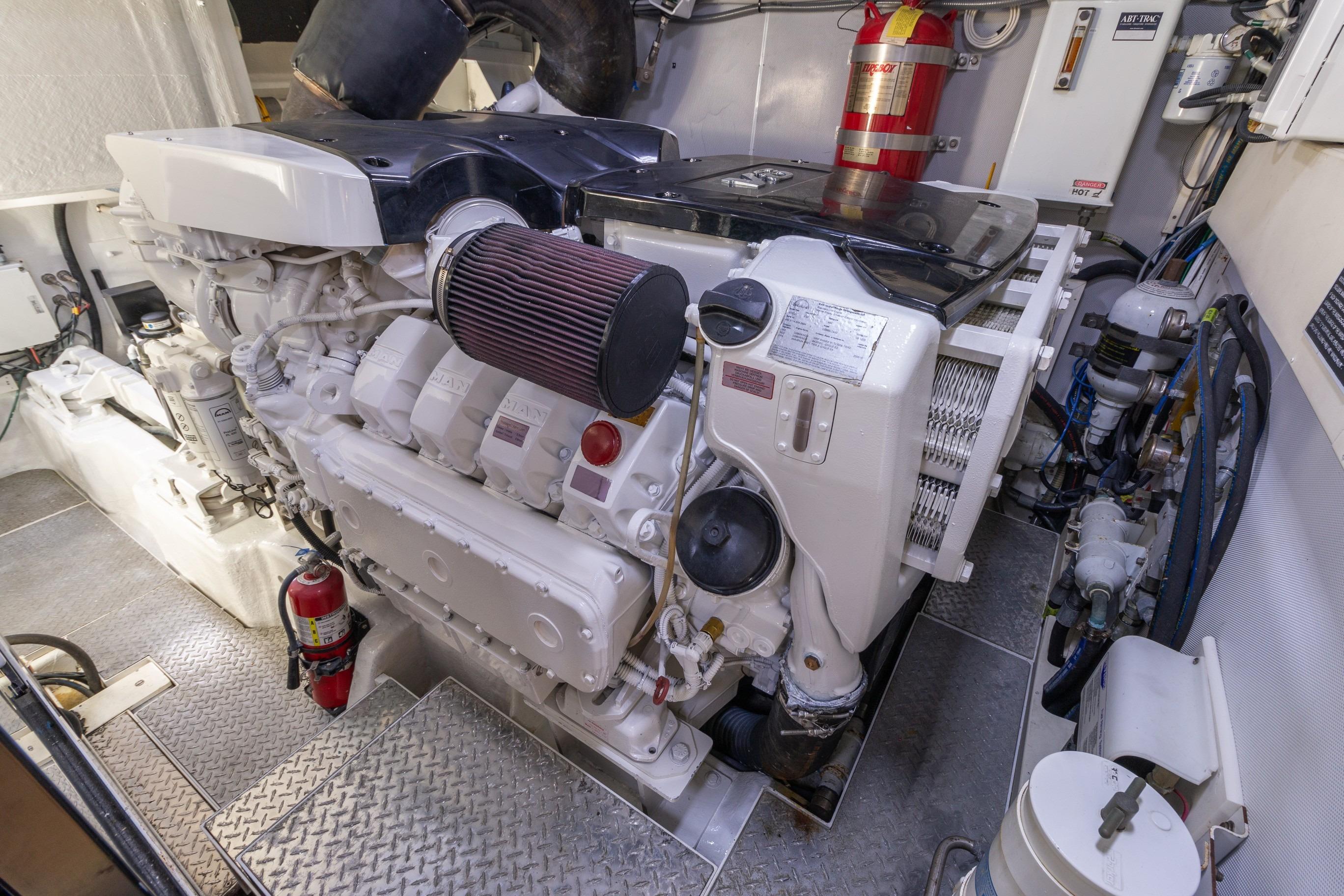 Engine room of 2012 Lazzara Breeze yacht with visible machinery and fire extinguisher.
