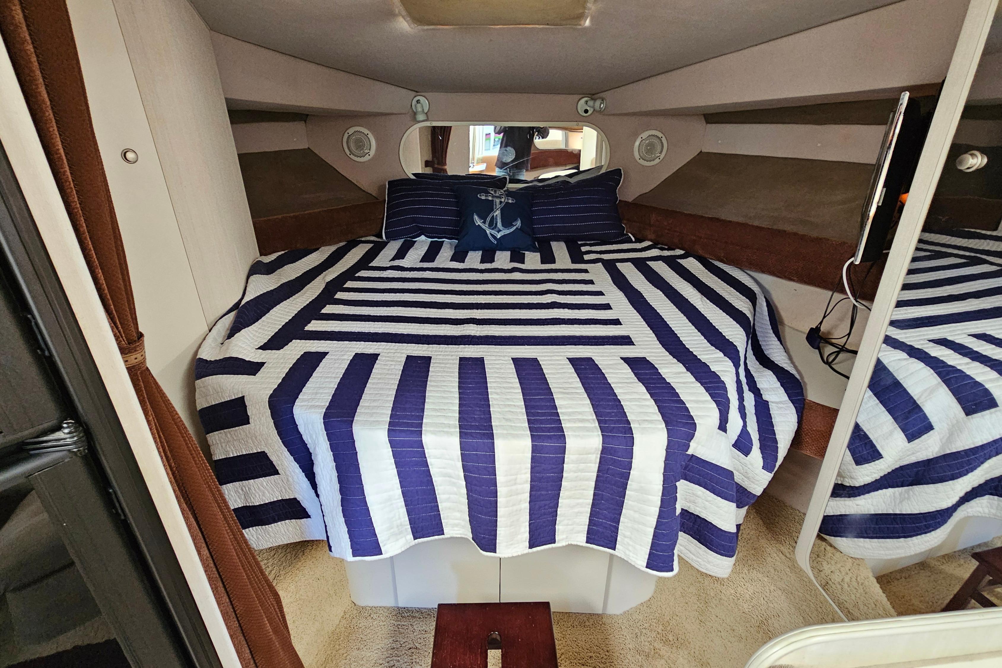 Interior cabin of 1995 Cruisers Yachts 3775 Esprit with striped bedding.