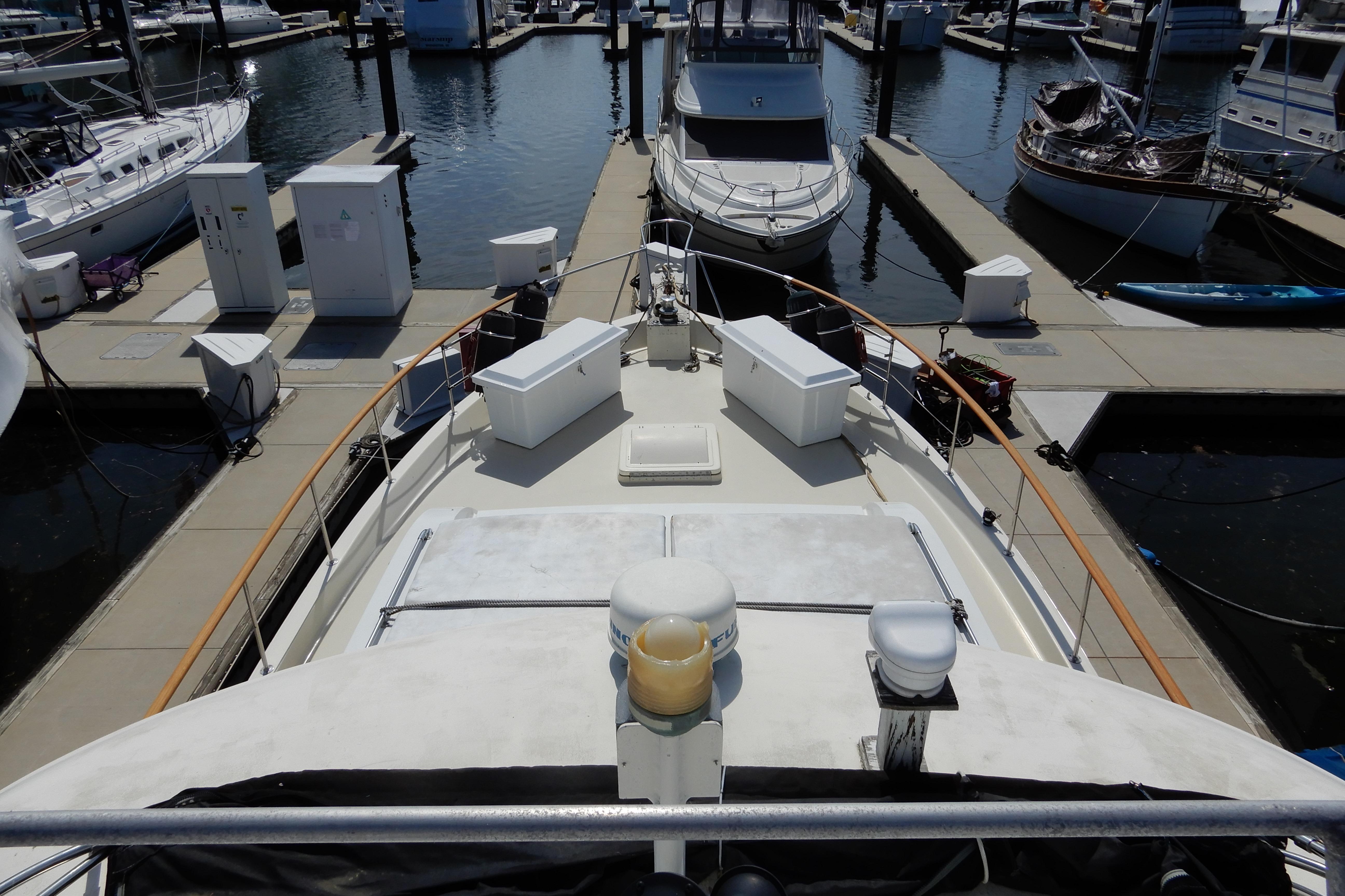 1974 Hatteras 53 Motor Yacht docked at marina, view from bow.