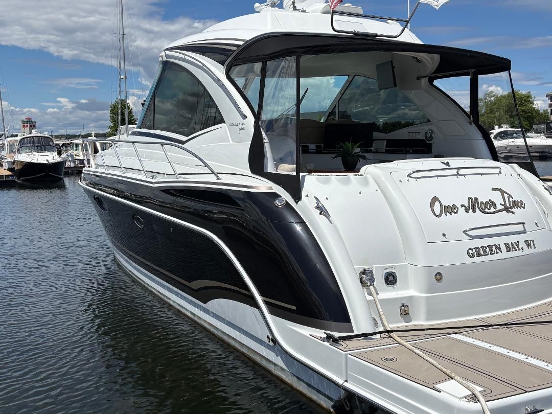 2011 Formula 45 yacht docked, sleek design, black and white paint.