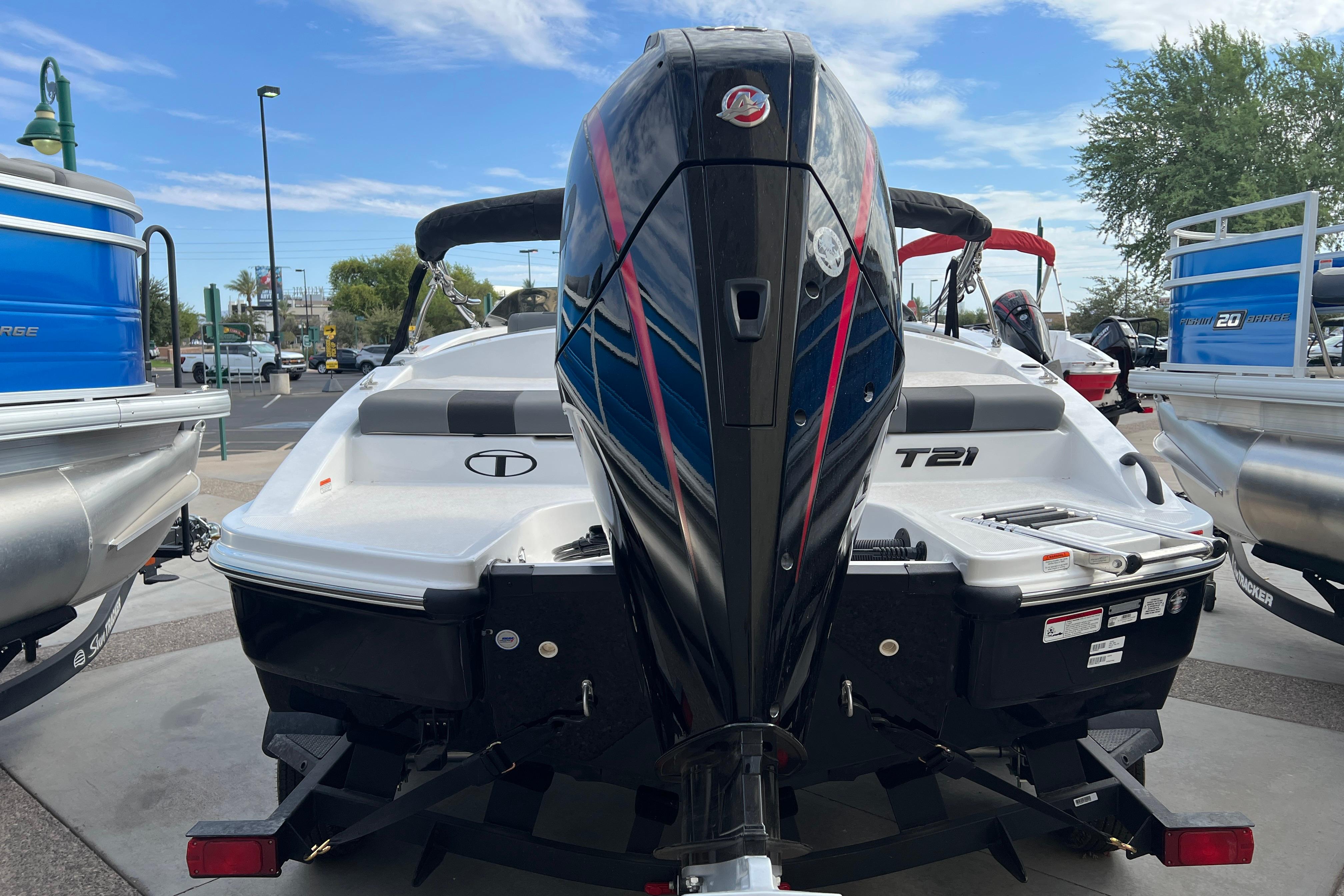 2026 Tahoe T21 boat with powerful outboard motor, displayed outdoors under a clear sky.