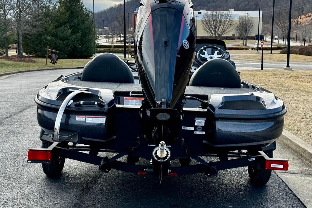 Rear view of a 2026 Nitro Z17 boat on a trailer in a parking lot.