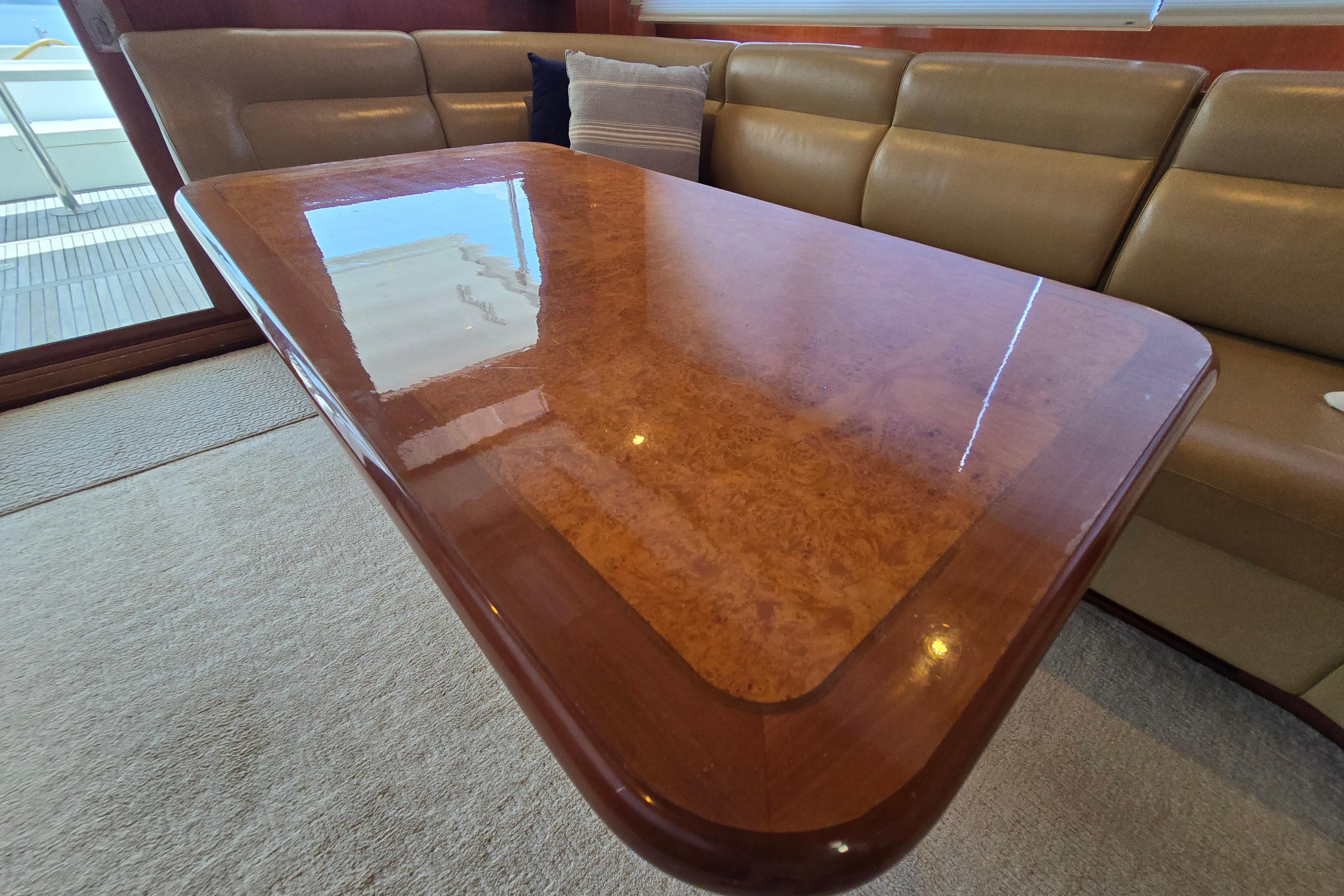 Luxurious wooden table in a 2004 Grand Harbour 58 yacht interior.