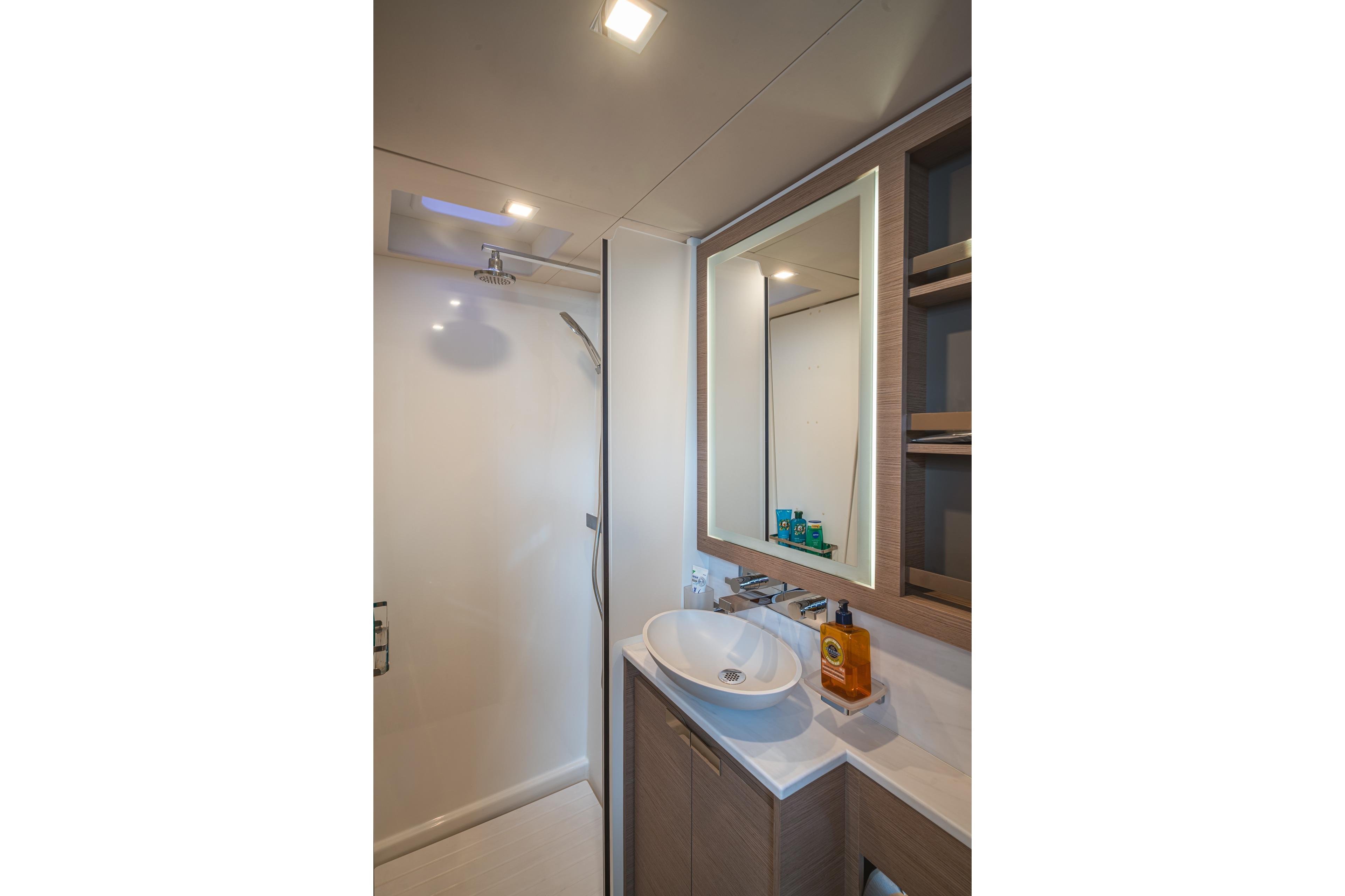 Luxurious bathroom interior of 2023 Fountaine Pajot Power 67 yacht with modern fixtures.