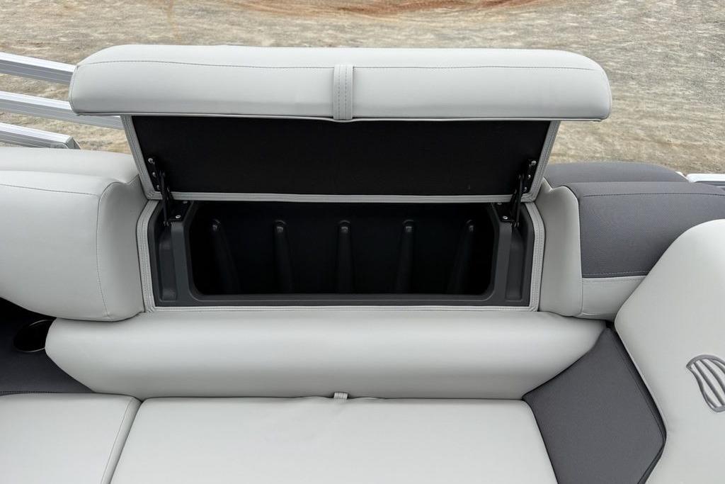 2026 Sun Tracker Fishin' Barge 20 DLX storage compartment with open seat lid.