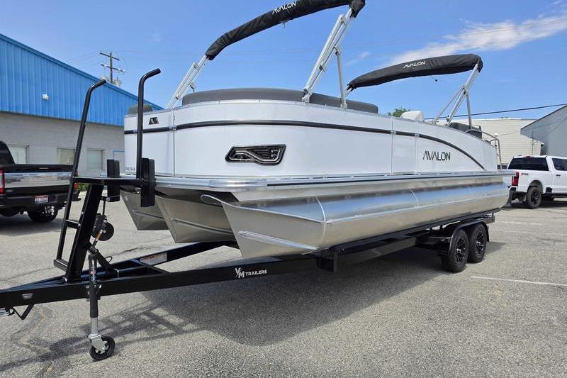 2026 Avalon Catalina Quad Lounge Shift pontoon boat on trailer in parking lot.