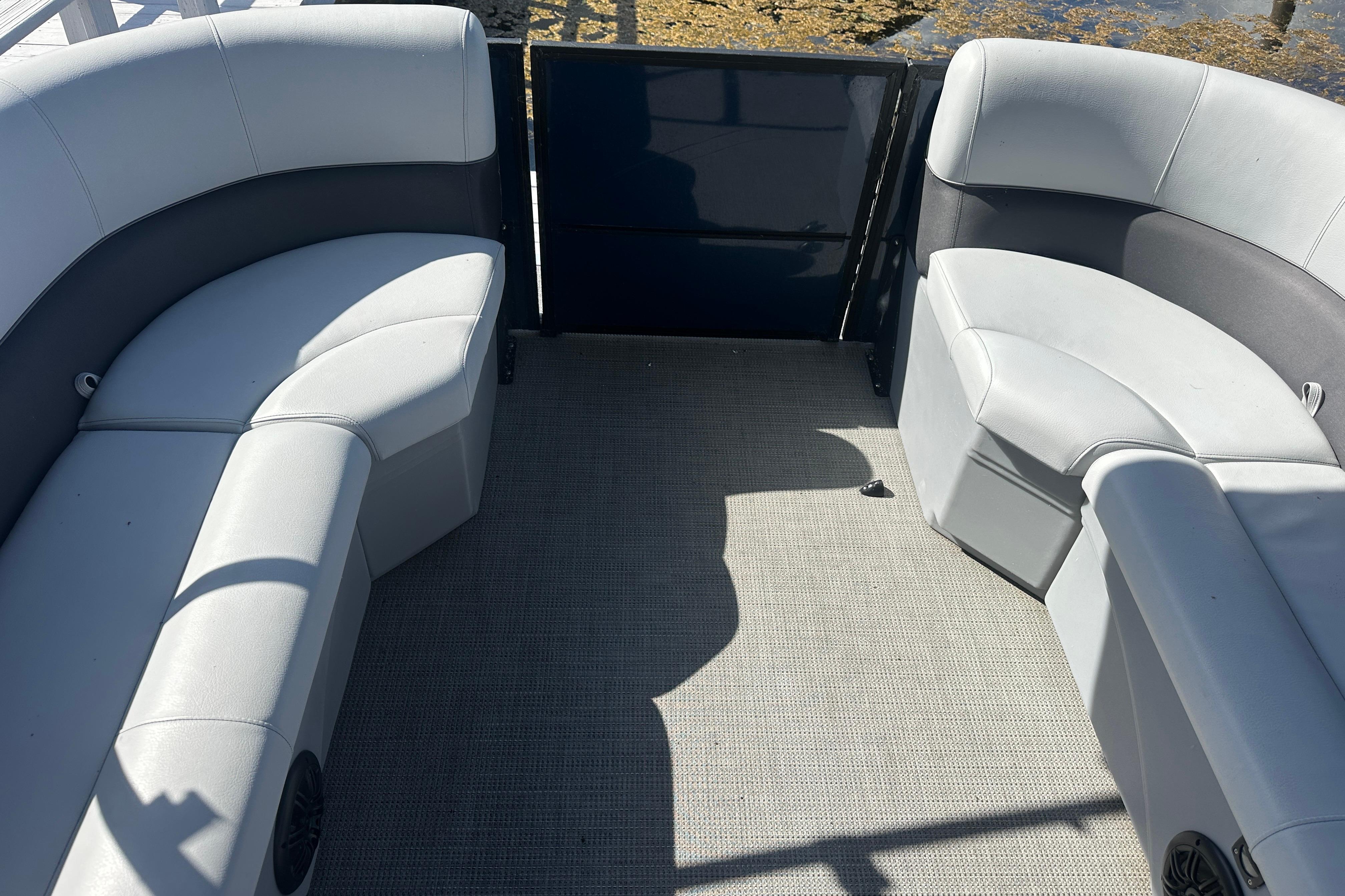 2023 Bentley Pontoons Legacy 243 Swingback interior with gray seating and carpeted floor.