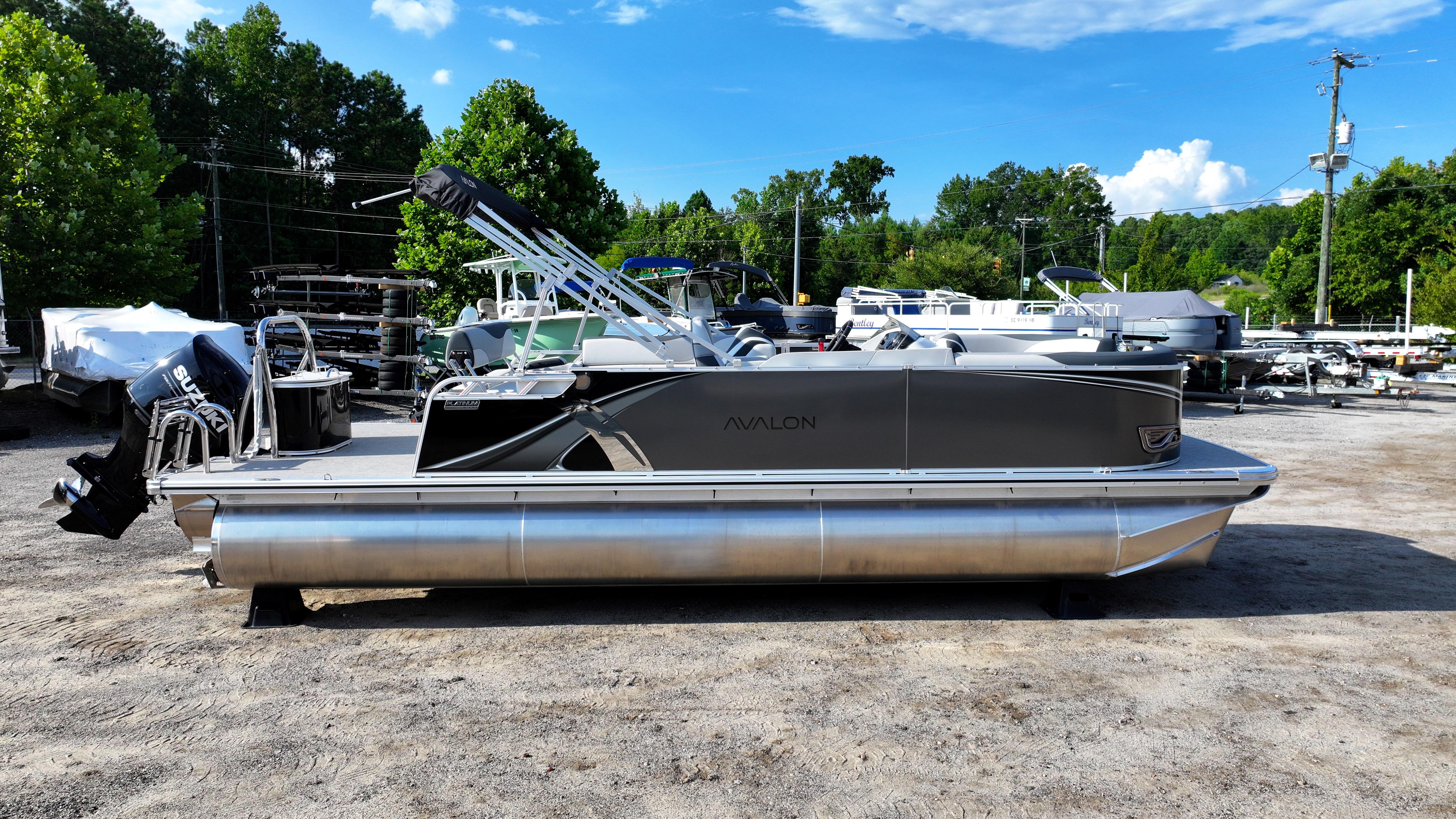 2025 Avalon LSZ Cruise Rear Bench pontoon boat in a marina setting.