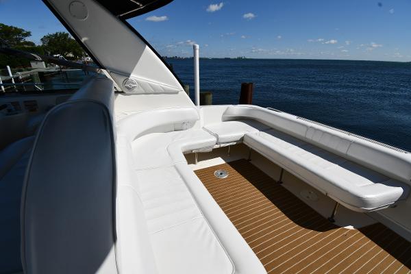 1997 Sea Ray 400 Sundancer yacht with spacious white seating and ocean view.