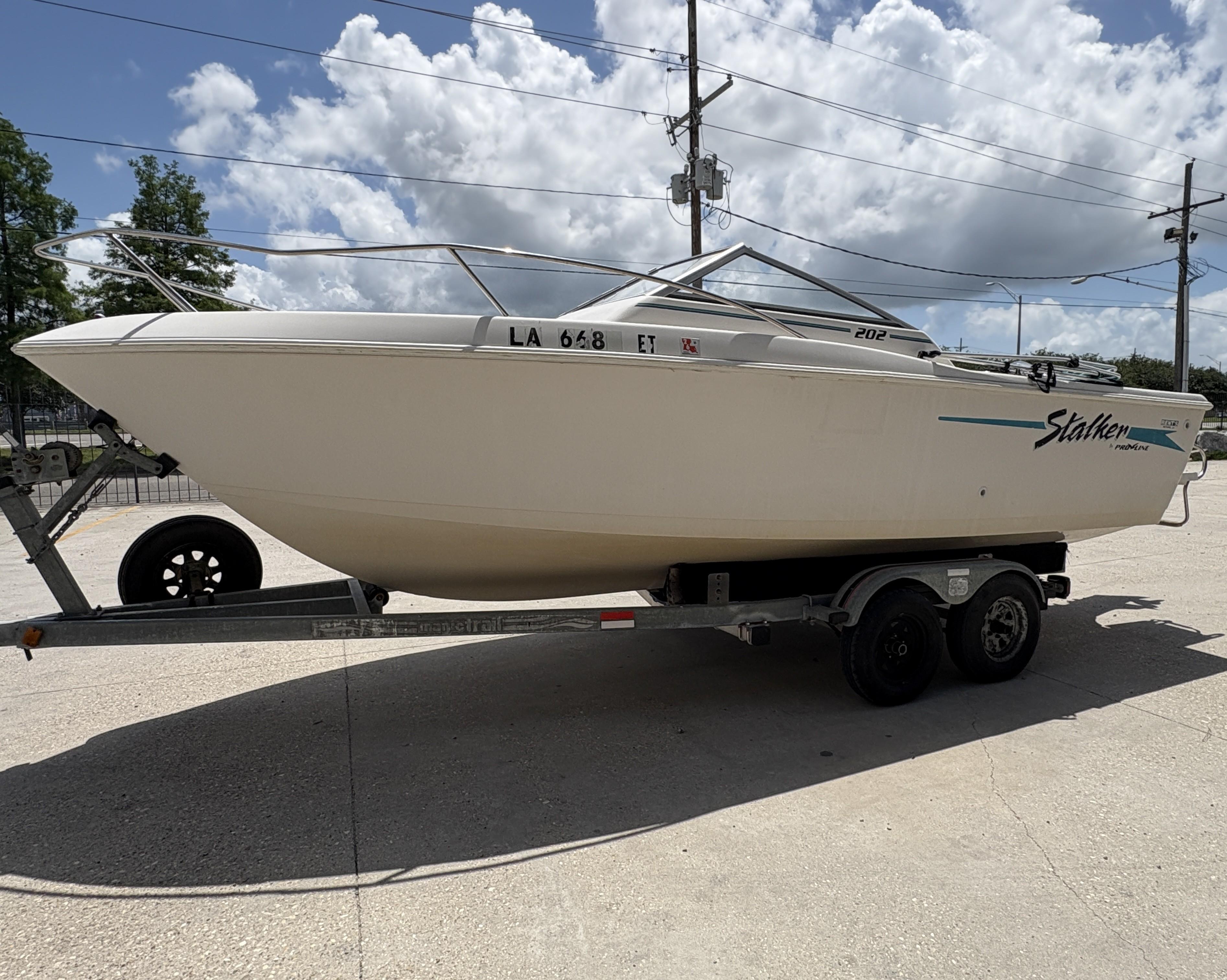 1996 Pro-Line 202 Stalker boat on trailer under cloudy sky.