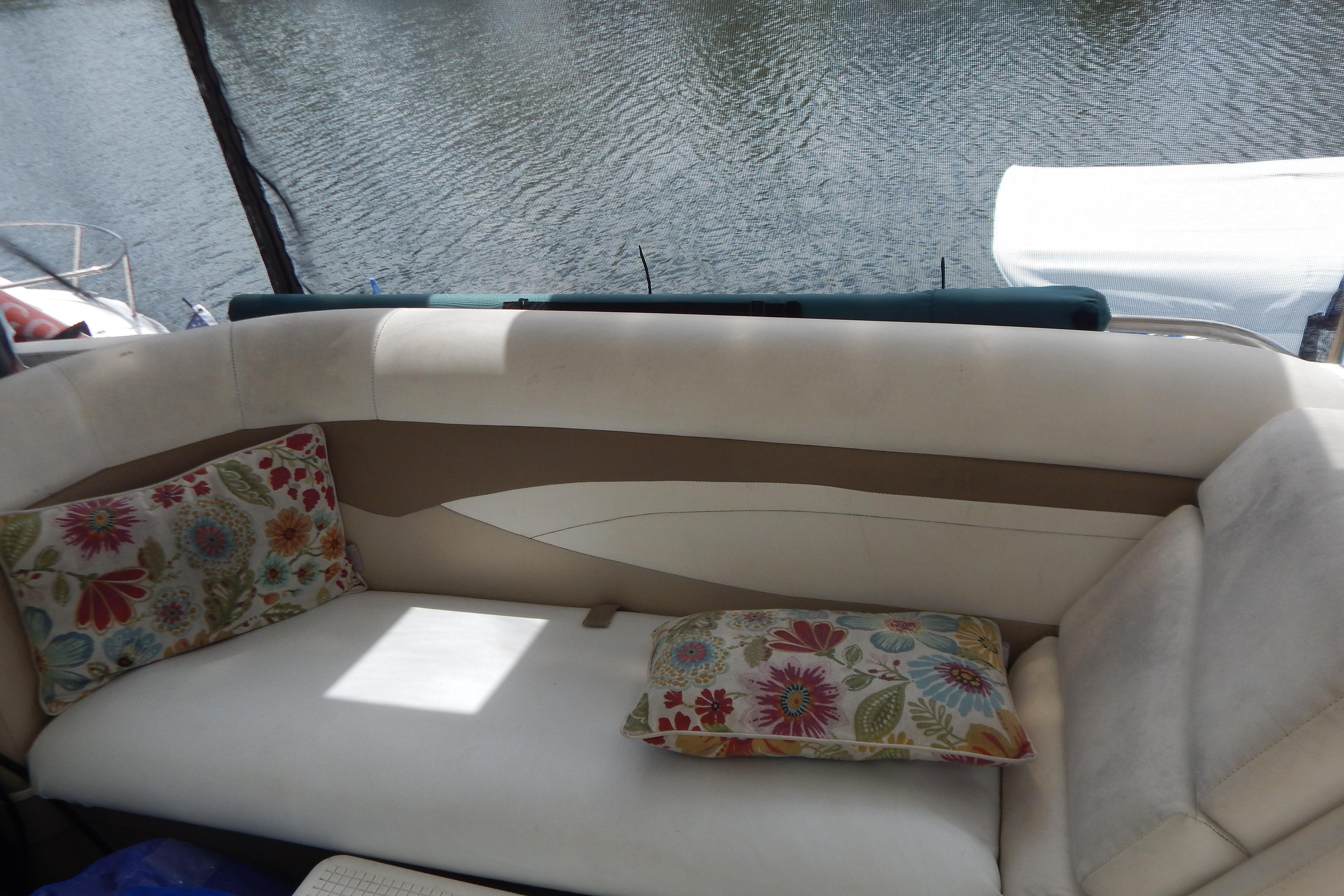 Interior of 1998 Magnum 4100 SCR boat with floral cushions on a beige sofa.